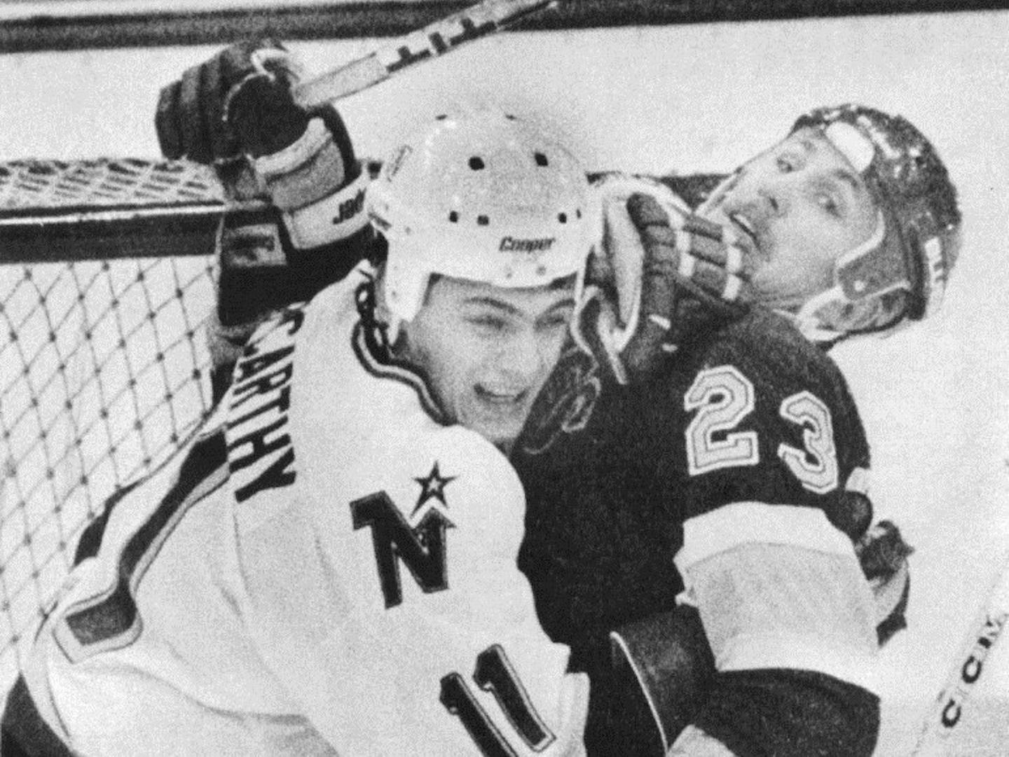 Minnesota North Star Tom McCarthy (11) and St. Louis Blue Lee Norwood (23) tied it up in front of the St. Louis goal during a 1985 game.