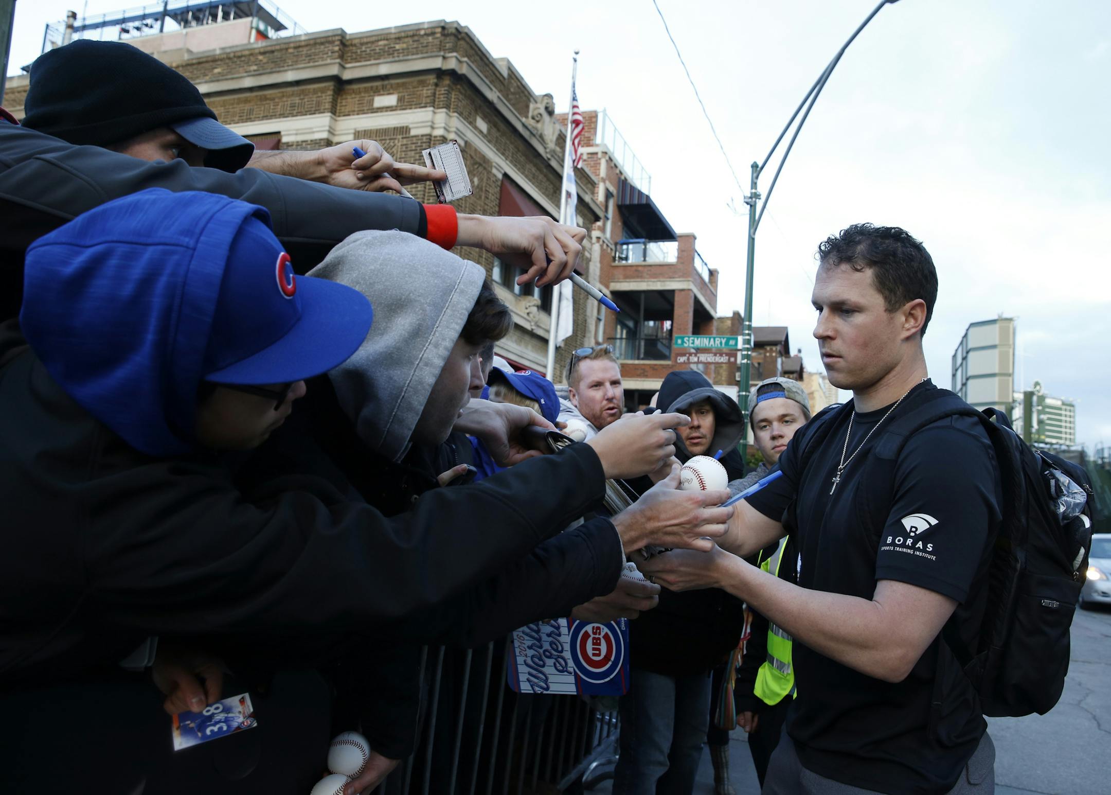 Chicago Cubs' Chris Coghlan signs autographs as he arrives at Wrigley Field for batting practice for Friday's Game 3 of the Major League Baseball World Series against the Cleveland Indians, Thursday, Oct. 27, 2016, in Chicago. (AP Photo/Nam Y. Huh)
