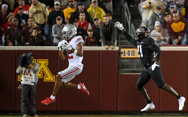 Ohio State Buckeyes wide receiver Chris Olave (2) caught a pass for a touchdown as he was defended by Minnesota Gophers defensive back Justus Harris (
