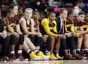 Minnesota players and coaches watch the final moments of an NCAA college basketball game against Maryland, Sunday, Feb. 26, 2017, in College Park, Md.