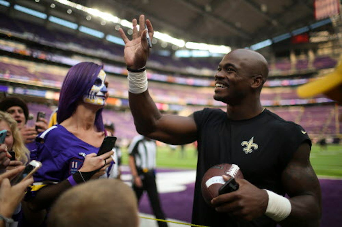 New Orleans Saints running back Adrian Peterson waved to fans in the stands while signing autographs on the sidelines during pregame warmups before Monday night's game.    ]  JEFF WHEELER ' jeff.wheeler@startribune.com