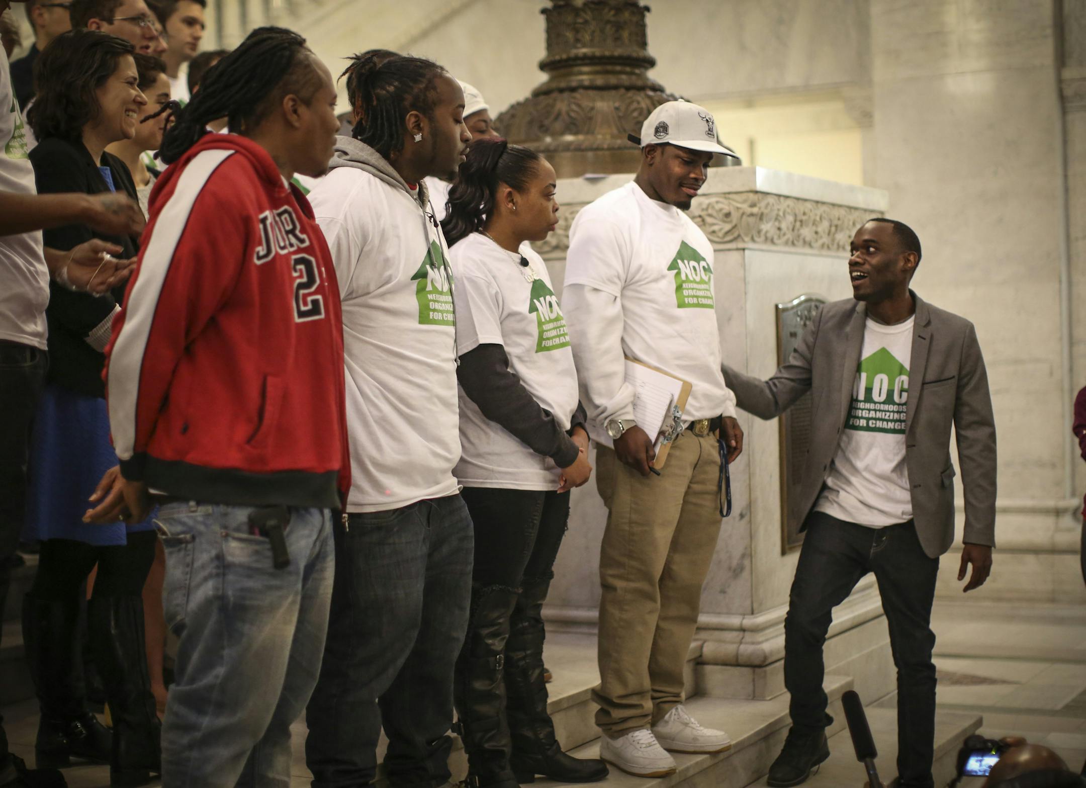 Mike Griffen, field director for Neighborhoods Organizing for Change, introduced Navell Gordon as they spoke to the media and a small crowd at City Hall before a city council meeting in Minneapolis, Minn., on Friday, April 3, 2015. ] RENEE JONES SCHNEIDER • reneejones@startribune.com Navell Gordon from pointergate