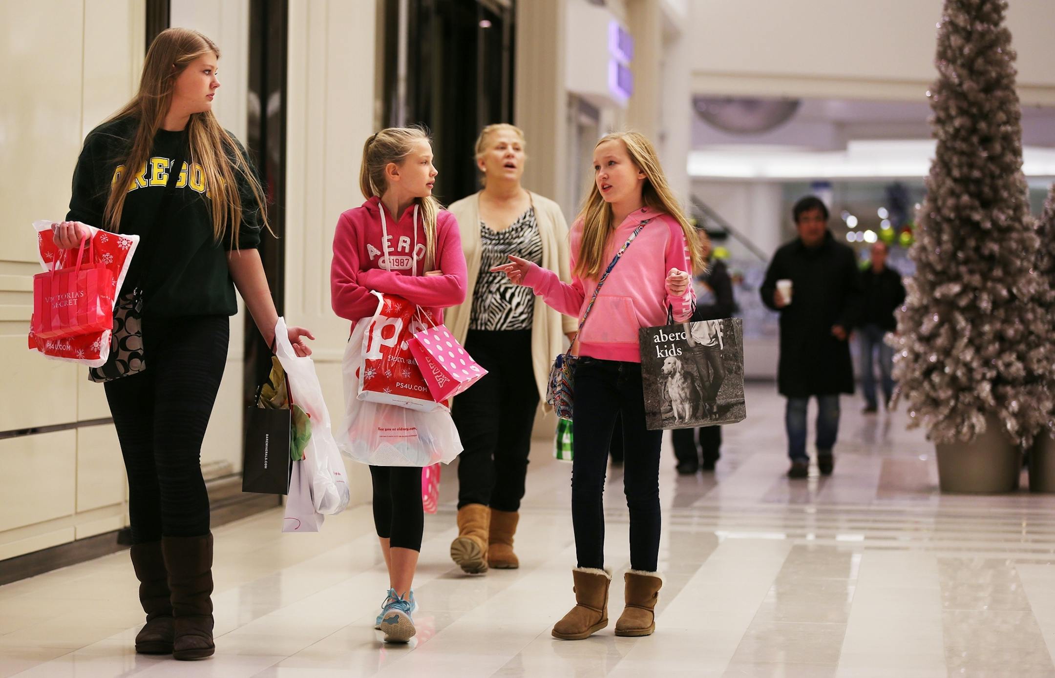 Katie Koch, 15, from left, her sister Emily Koch, 13, both of Bloomington, and their cousin Erin Peterson, 12, of Maple Grove shop on Black Friday at Mall of America in Bloomington on Friday, November 28, 2014.