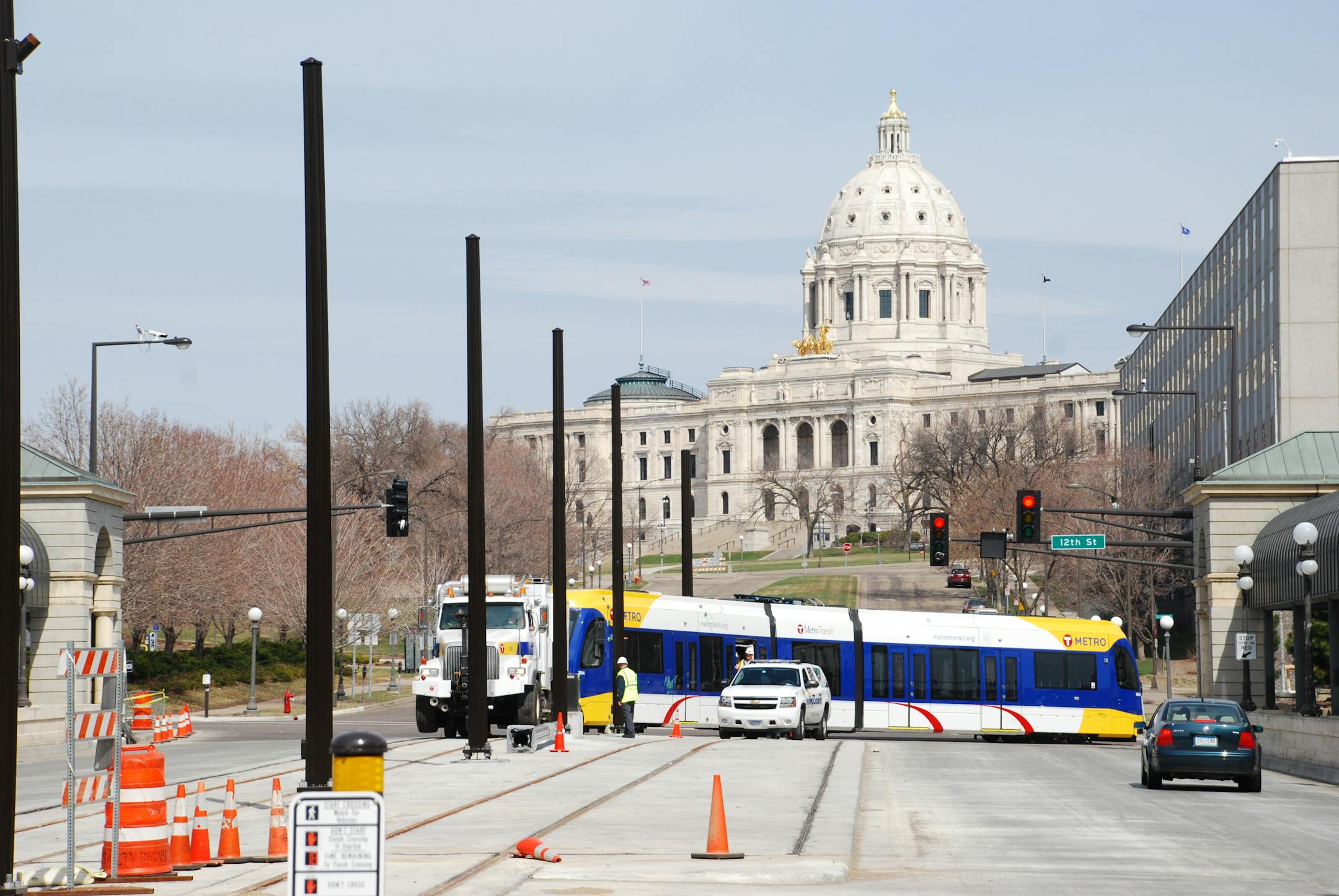 LRV being towed through the intersection of 11th and Cedar, heading south on the Cedar Street bridge over Interstate 94 toward the Tenth Street Station in St. Paul.