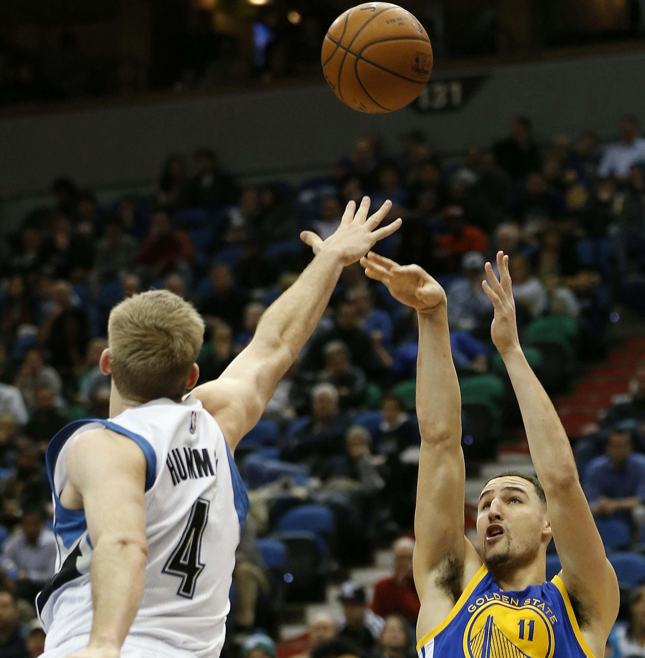 Golden State Warriors guard Klay Thompson (11) shoots the ball against Minnesota Timberwolves forward Robbie Hummel (4) during the second half of an NBA basketball game Monday, Dec, 8, 2014, in Minneapolis. The Warriors won 102-86. (AP Photo/Stacy Bengs)