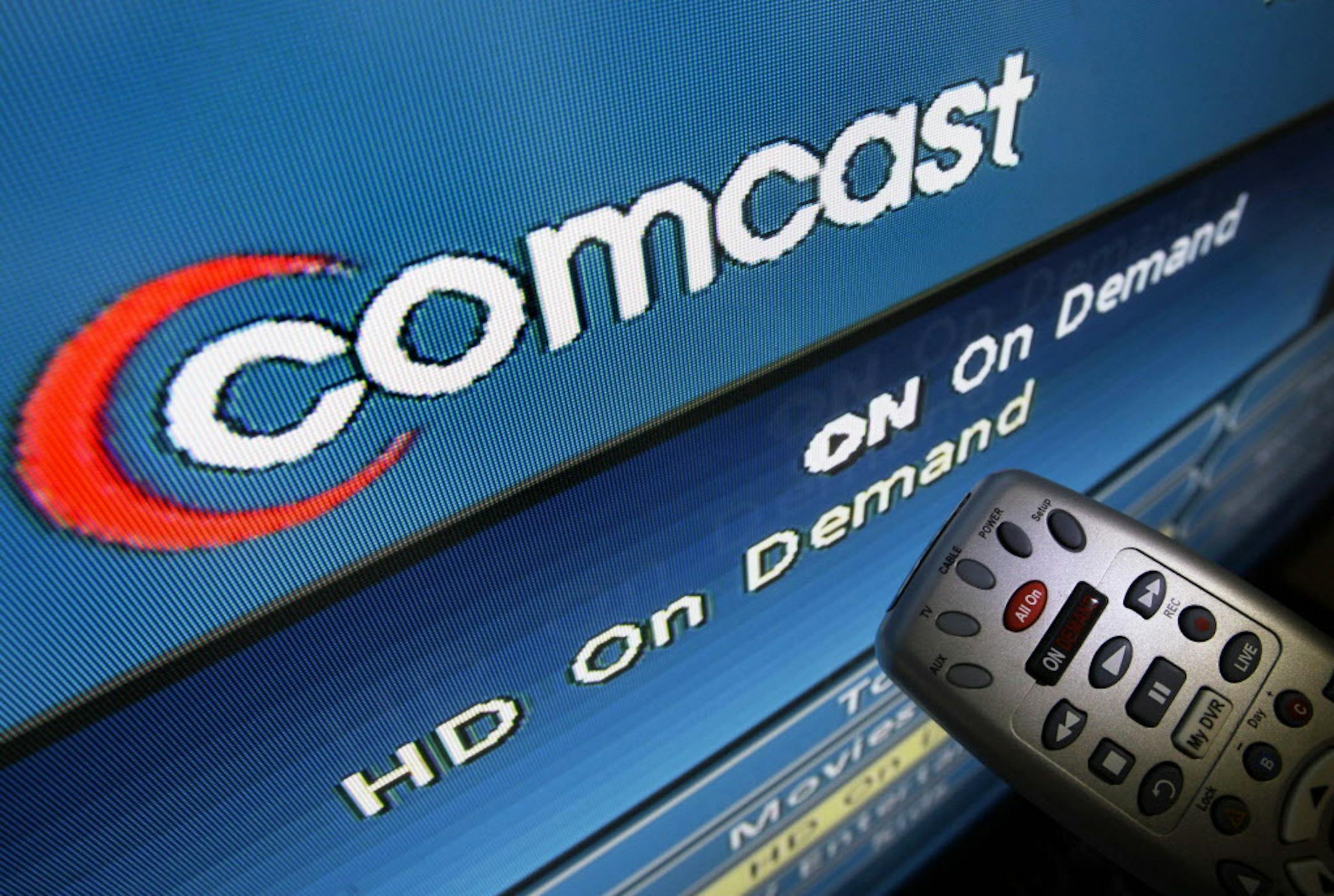 The Comcast logo is displayed on a TV set in North Andover, Mass. Thursday, Aug. 6, 2009. Comcast Corp., the nation's biggest cable TV systems operator, posted a 53 percent increase in second-quarter profit on Thursday, helped by higher prices and increased customer spending on video and Internet services. But subscriber growth markedly slowed as the recession's grip remained tight. (AP Photo/Elise Amendola)