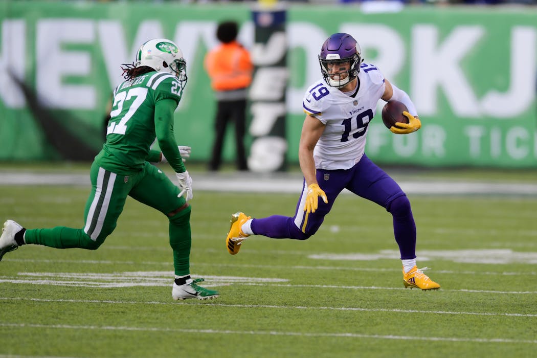 The Vikings' Adam Thielen runs away from the Jets' Darryl Roberts