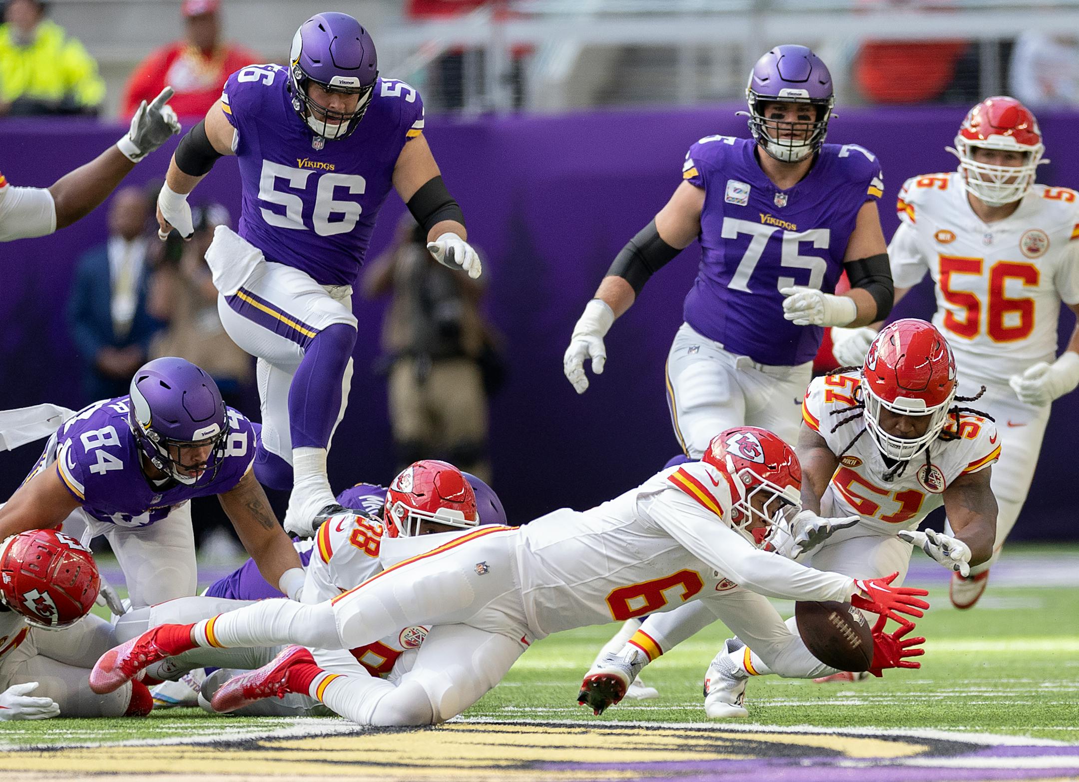 Chiefs safety Bryan Cook (6) recovered a ball fumbled by Vikings tight end Josh Oliver (84) in the first quarter, Sunday, Oct. 8, 2023 in Minneapolis. The Minnesota Vikings hosted the Kansas City Chiefs at U.S. Bank Stadium.
