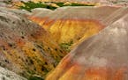 Visitors to Badlands National Park can witness a naturally occuring color palette of pinks and yellows on the rock faces as they drive the Badlands Sc