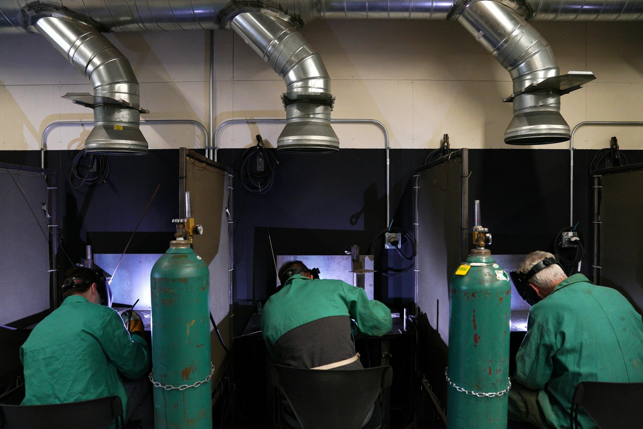 A blue glow lit up the room as students practiced their welding technique.