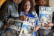 Kimberly Handy Jones flanked by Clyde McLemore left and her sister Nanette Adams held a poster of her son Cordale Handy who was killed by St. Paul Pol