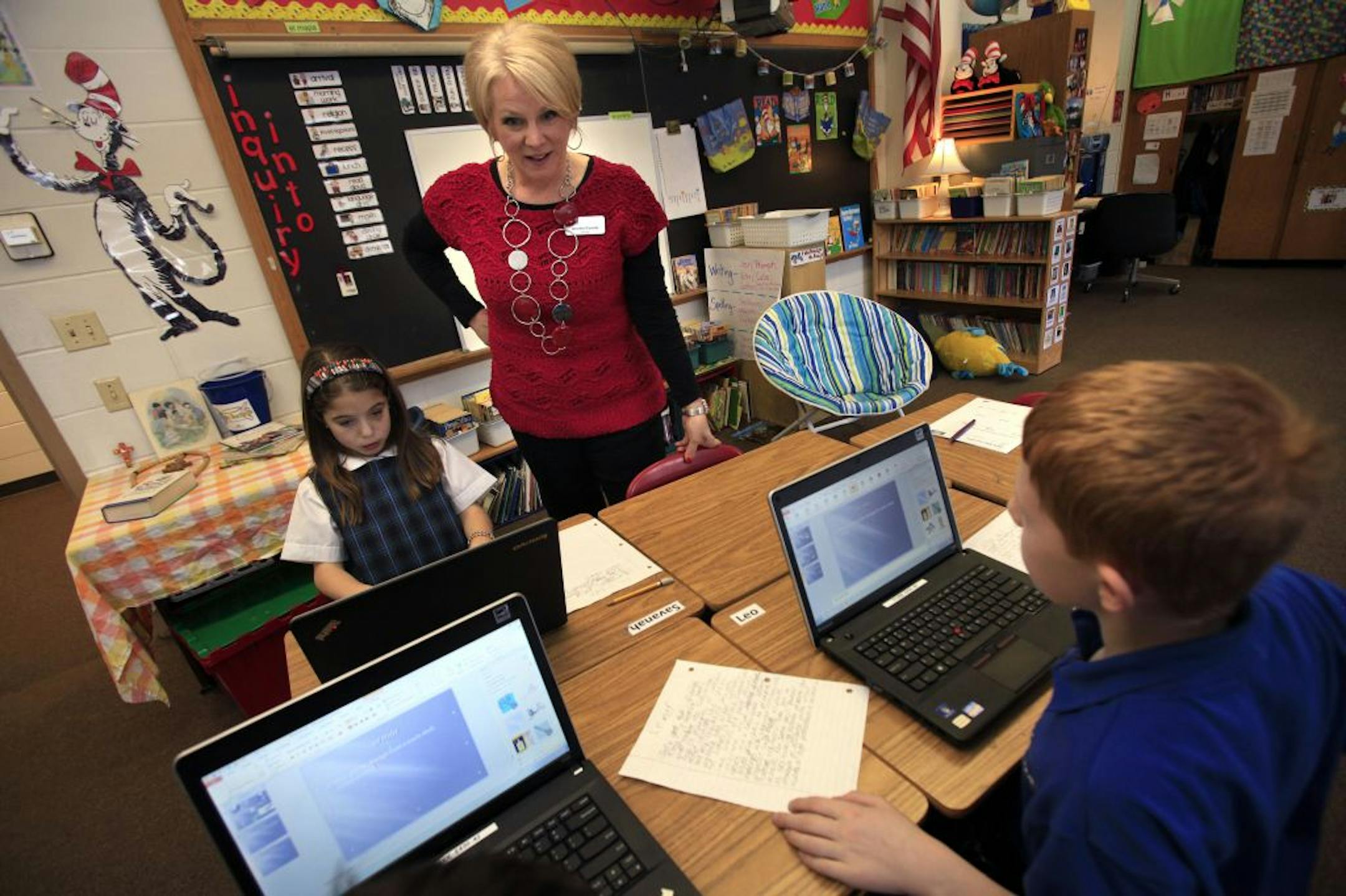 Principal Jennifer Cassidy of St. Jude of the Lake school in Mahtomedi, MN talked with 3rd grade students Savanah L'allier (left) about their power point presentation that they were working on. Mahtomedi, MN January 16, 2013.