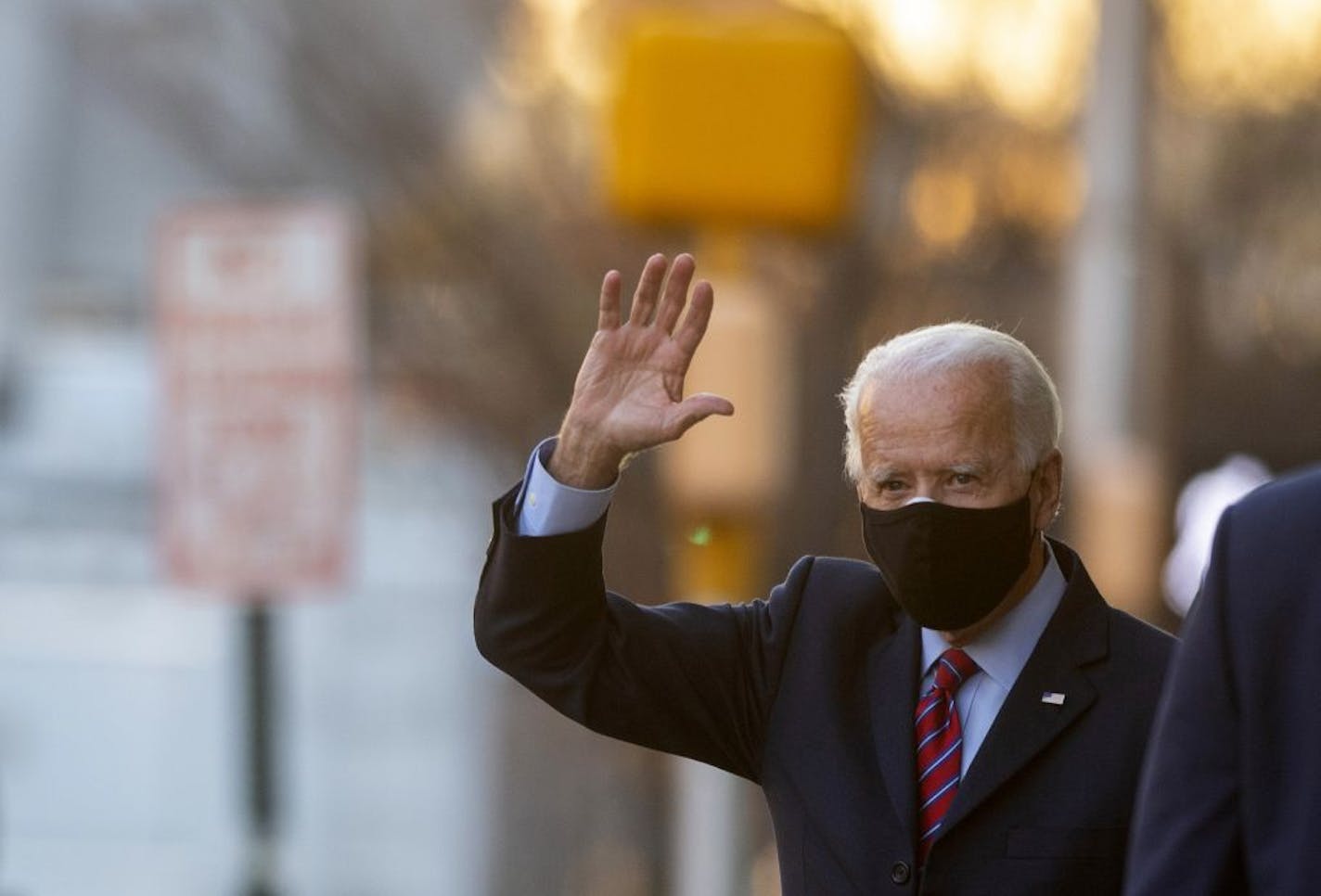 President-elect Joe Biden waves as he departed the Queen Theatre after meeting virtually with the United States Conference of Mayors in Wilmington, Delaware, on Monday, Nov. 23, 2020.