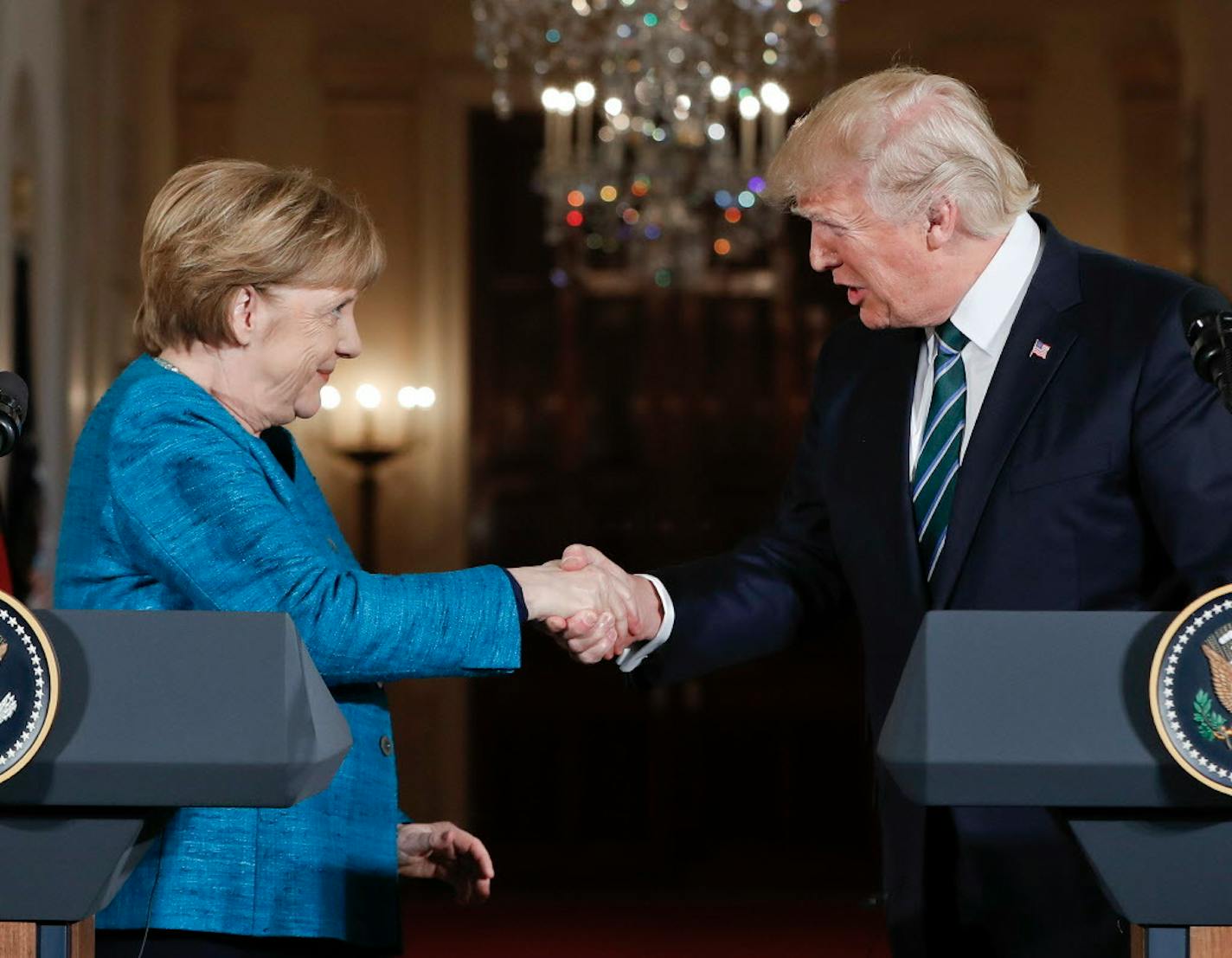 German Chancellor Angela Merkel and President Donald Trump shake hands after their joint news conference Friday.