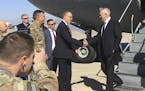 U.S. Secretary of Defense Jim Mattis, center, is greeted by U.S. Ambassador Douglas Silliman as he arrives at Baghdad International Airport on an unan
