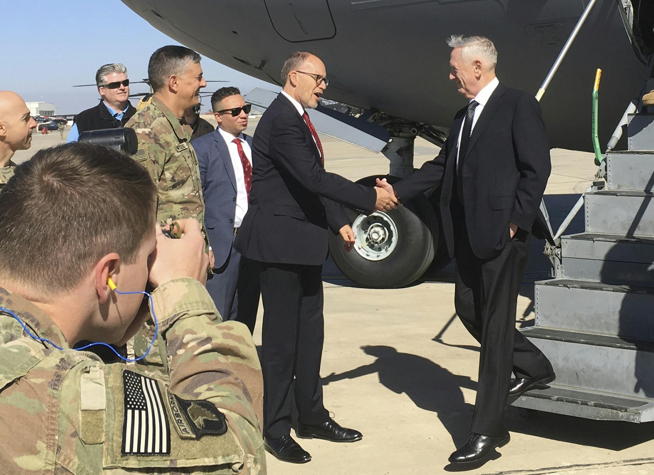 U.S. Secretary of Defense Jim Mattis, center, is greeted by U.S. Ambassador Douglas Silliman as he arrives at Baghdad International Airport on an unannounced trip Monday, Feb. 20, 2017. Mattis said Monday the United States does not intend to seize Iraqi oil, shifting away from an idea proposed by President Donald Trump that has rattled Iraq's leaders. (AP Photo/Lolita Baldor)