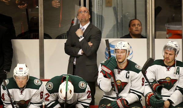 Minnesota Wild coach Mike Yeo and players on the bench in the final minutes of the game. Chicago beat Minnesota by a final score of 4-1. ] CARLOS GONZ
