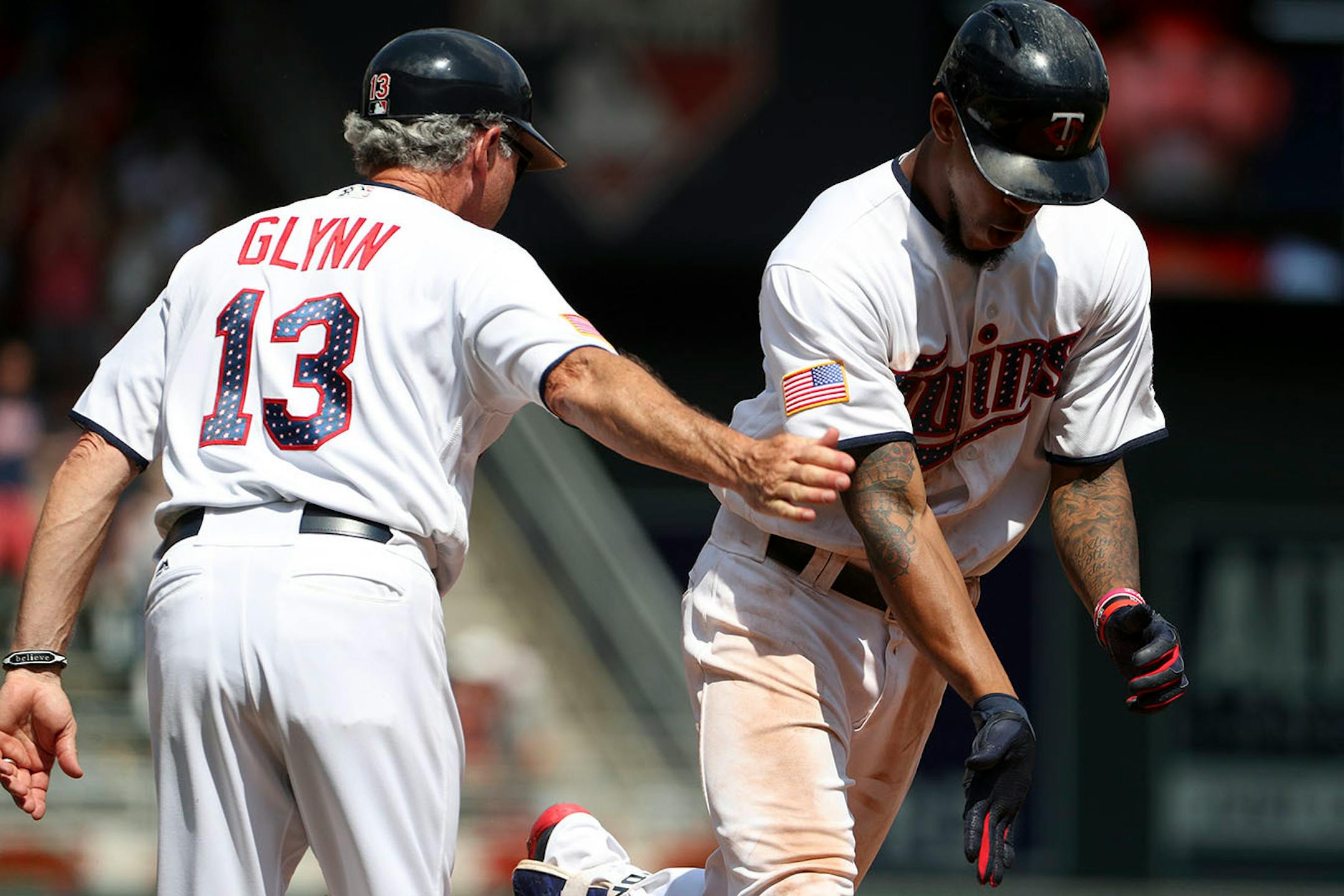 Minnesota Twins center fielder Byron Buxton (25) celebrated with Minnesota Twins third base coach Gene Glynn (13) as he rounded third base to score after hitting a home run in the sixth inning.