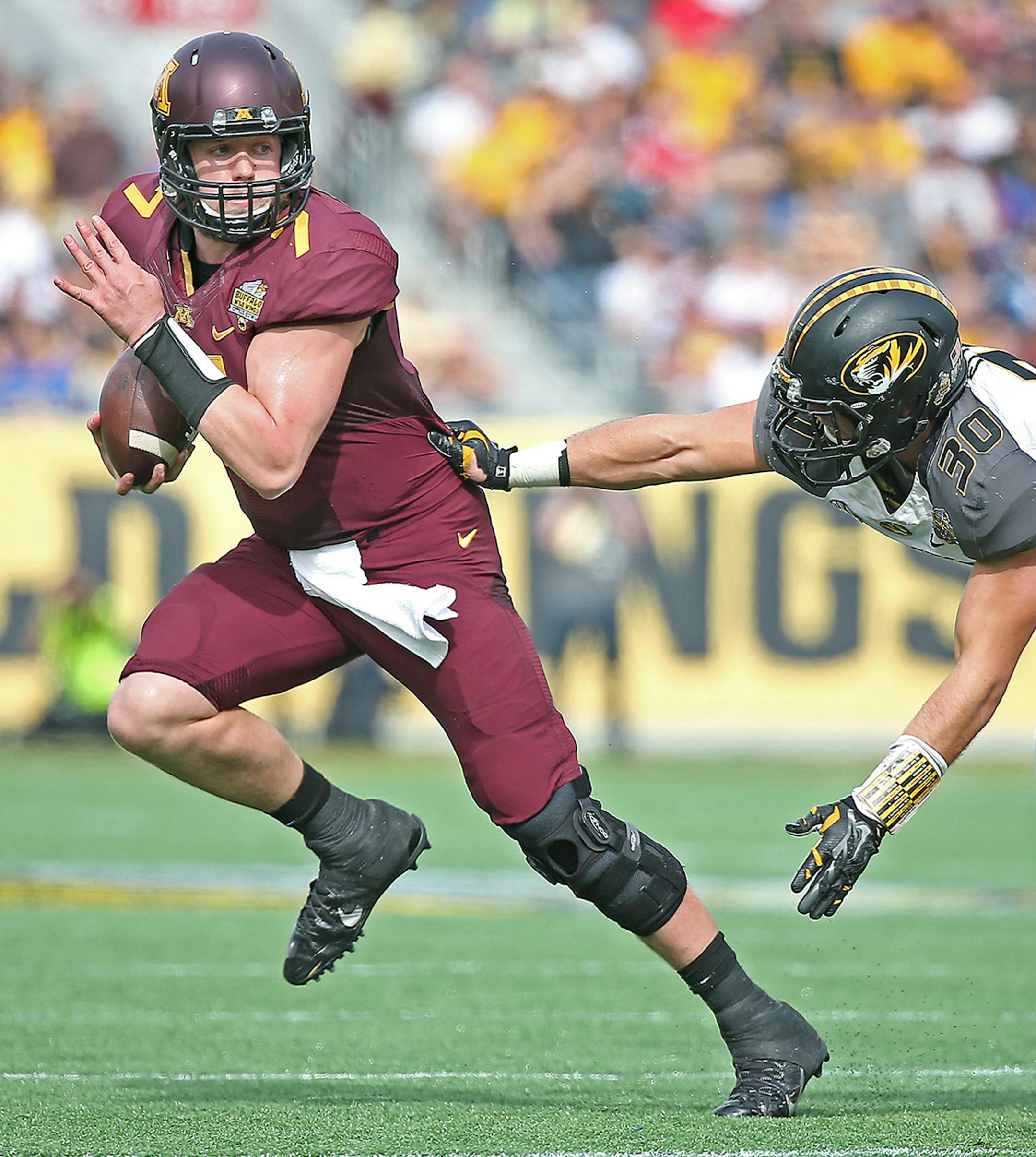 Minnesota quarterback Mitch Leidner (7) runs for yards despite pressure from Missouri linebacker Michael Scherer (30) during the first quarter of the Citrus Bowl at Citrus Bowl Stadium, Thursday, Jan. 1, 2015 in Orlando, Fla. Missouri won 33-17. (Elizabeth Flores/Minneapolis Star Tribune/TNS) ORG XMIT: 1162151 ORG XMIT: MIN1501011537220014