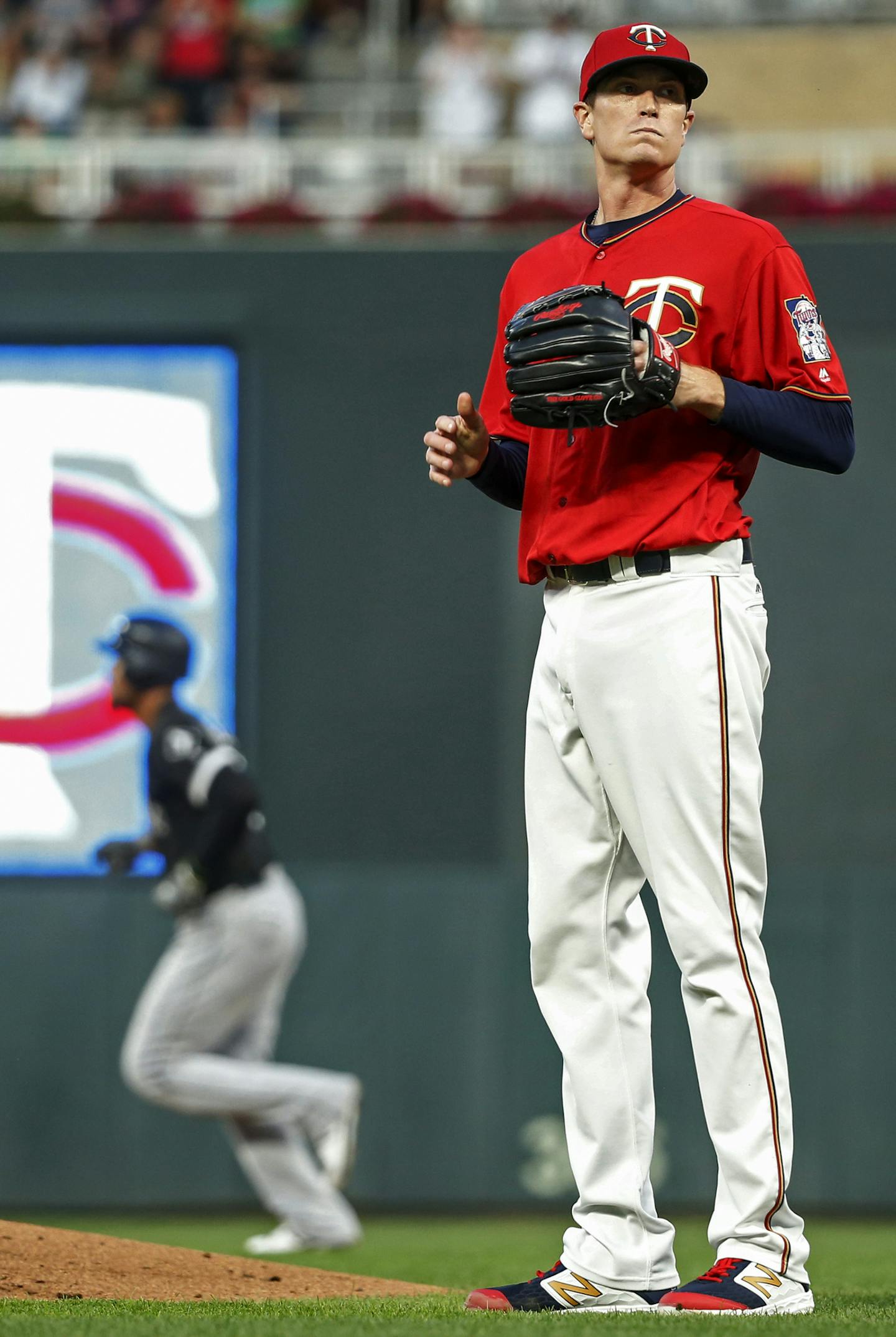 Minnesota Twins starting pitcher Kyle Gibson waits for a new ball as Chicago White Sox's Jose Abreu runs the bases on his three-run home run in the third inning of a baseball game Monday, Aug 19, 2019, in Minneapolis. (AP Photo/Bruce Kluckhohn)