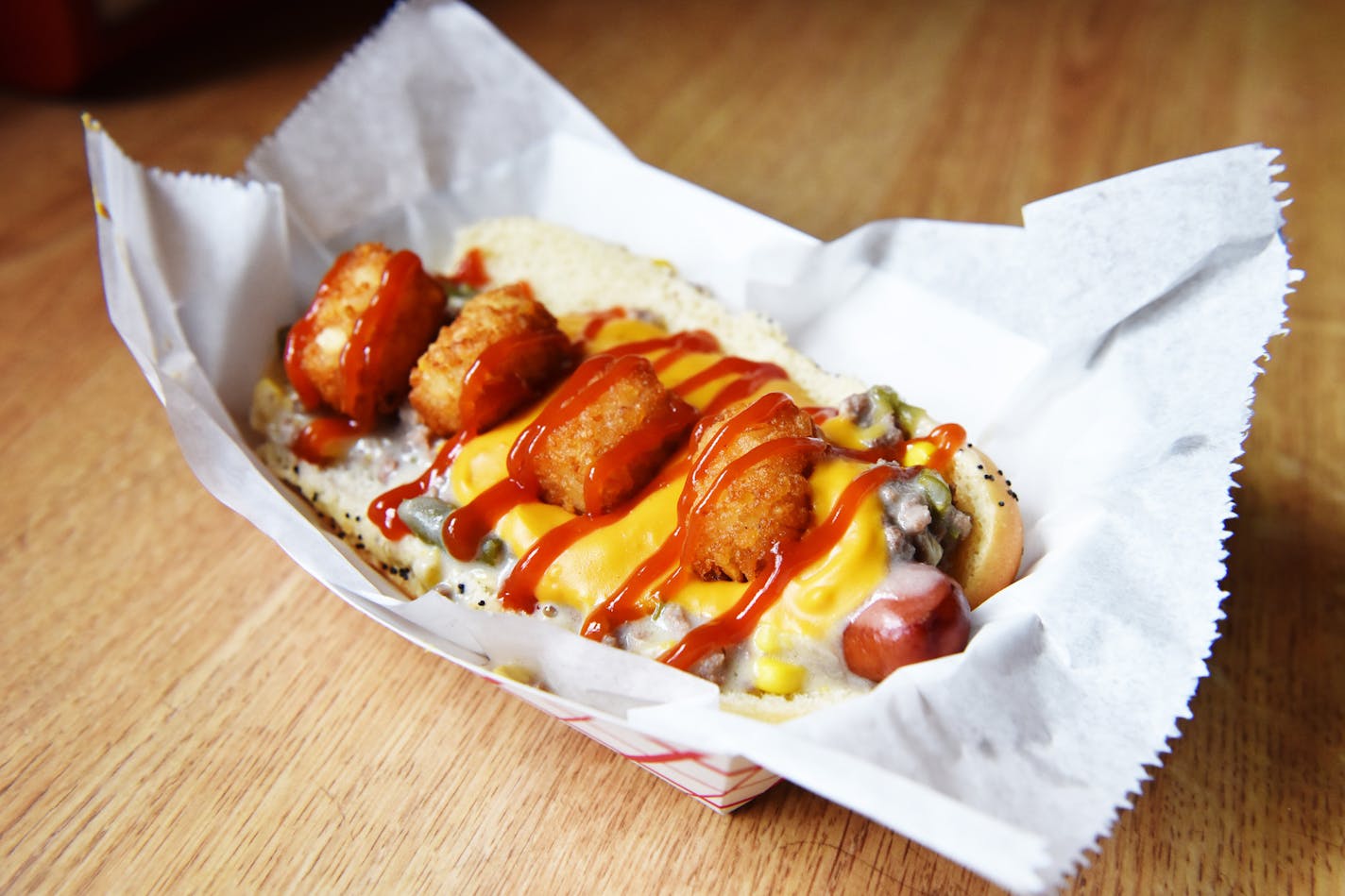 The MPLS Dog at Uncle Franky's is a beef dog smothered in green beans, corn, cream of mushroom soup, cheese, tater tots and ketchup. ] MARK VANCLEAVE &#xef; mark.vancleave@startribune.com * The MPLS Dog at Uncle Franky's in Minneapolis photographed Friday, July 21, 2017.