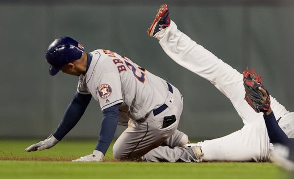 Houston Astros Michael Brantley slid safely into second base after hitting a double in the sixth inning.