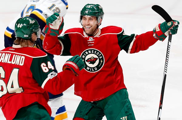 The Wild's Mikael Granlund (64) and Jason Zucker (16) celebrated a goal by Granlund in the third period against the Blues on Thursday. ] CARLOS GONZAL