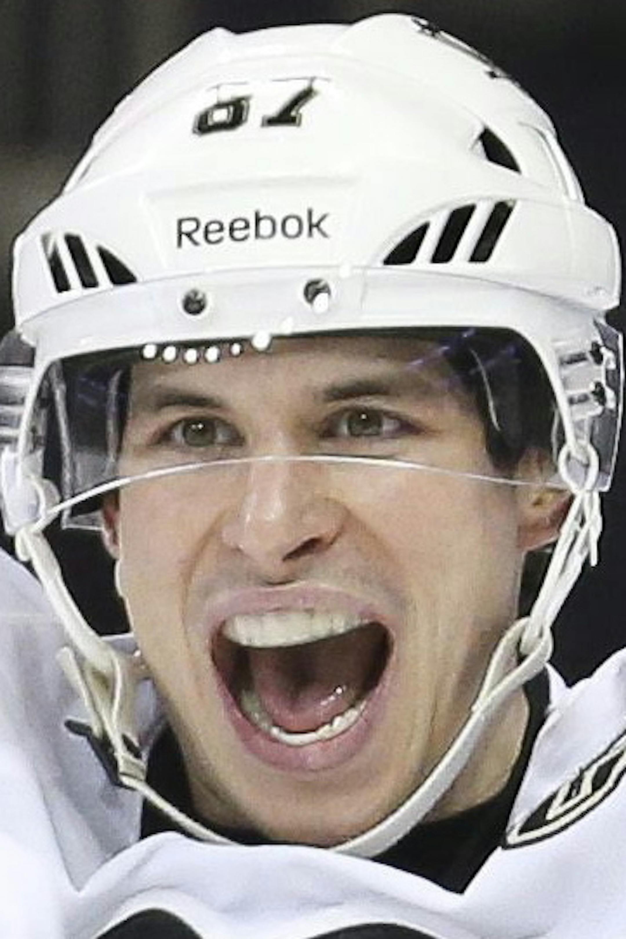 FILE - In this Dec. 18, 2013 file photo, Pittsburgh Penguins center Sidney Crosby (87) reacts after right wing Pascal Dupuis (9) scored during the third period of an NHL hockey game against the New York Rangers in New York. Crosby was named to Canada's men's national hockey team for the Sochi Olympics on Tuesday, Jan. 7, 2014. (AP Photo/John Minchillo, File)