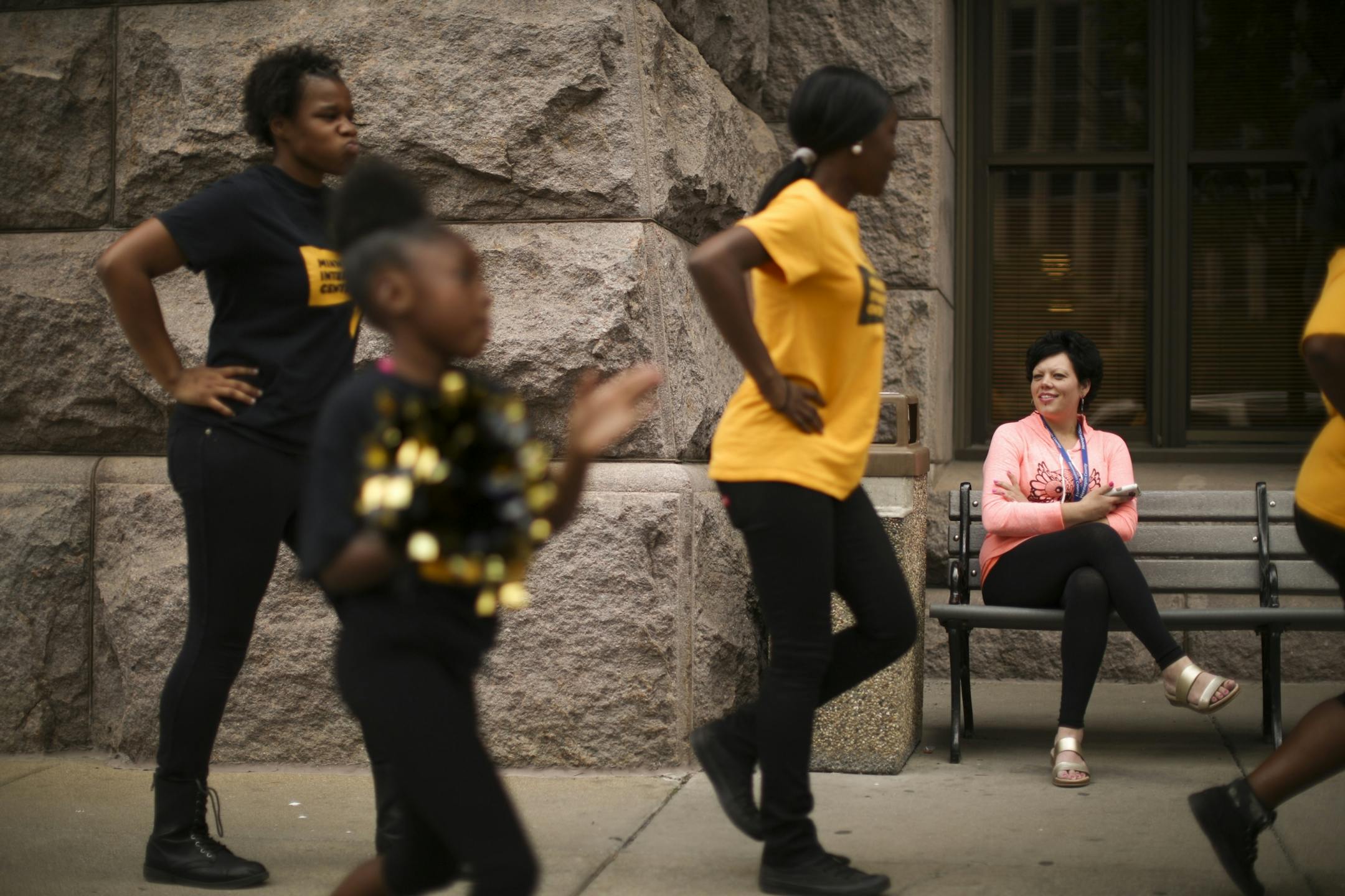 Kimberly Vargas watched as the minimum wage demonstrators marched around City Hall Wednesday afternoon.