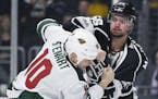 Los Angeles Kings defenseman Kurtis MacDermid, right, fights Minnesota Wild right wing Chris Stewart during the first period of an NHL hockey game in 