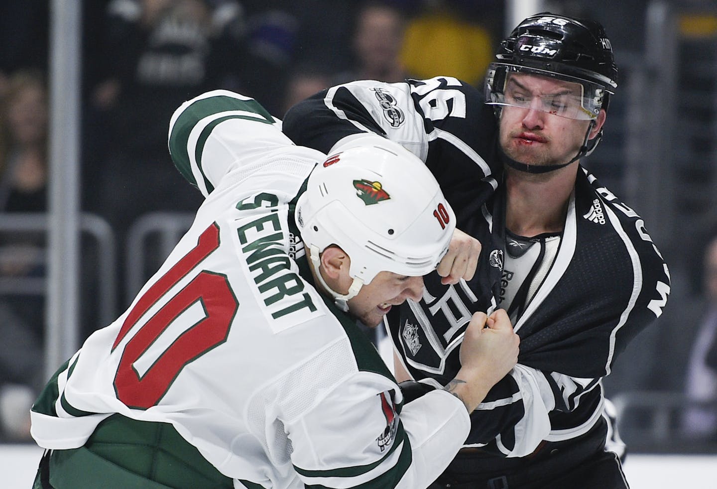 Los Angeles Kings defenseman Kurtis MacDermid, right, fights Minnesota Wild right wing Chris Stewart during the first period of an NHL hockey game in Los Angeles, Tuesday, Dec. 5, 2017.