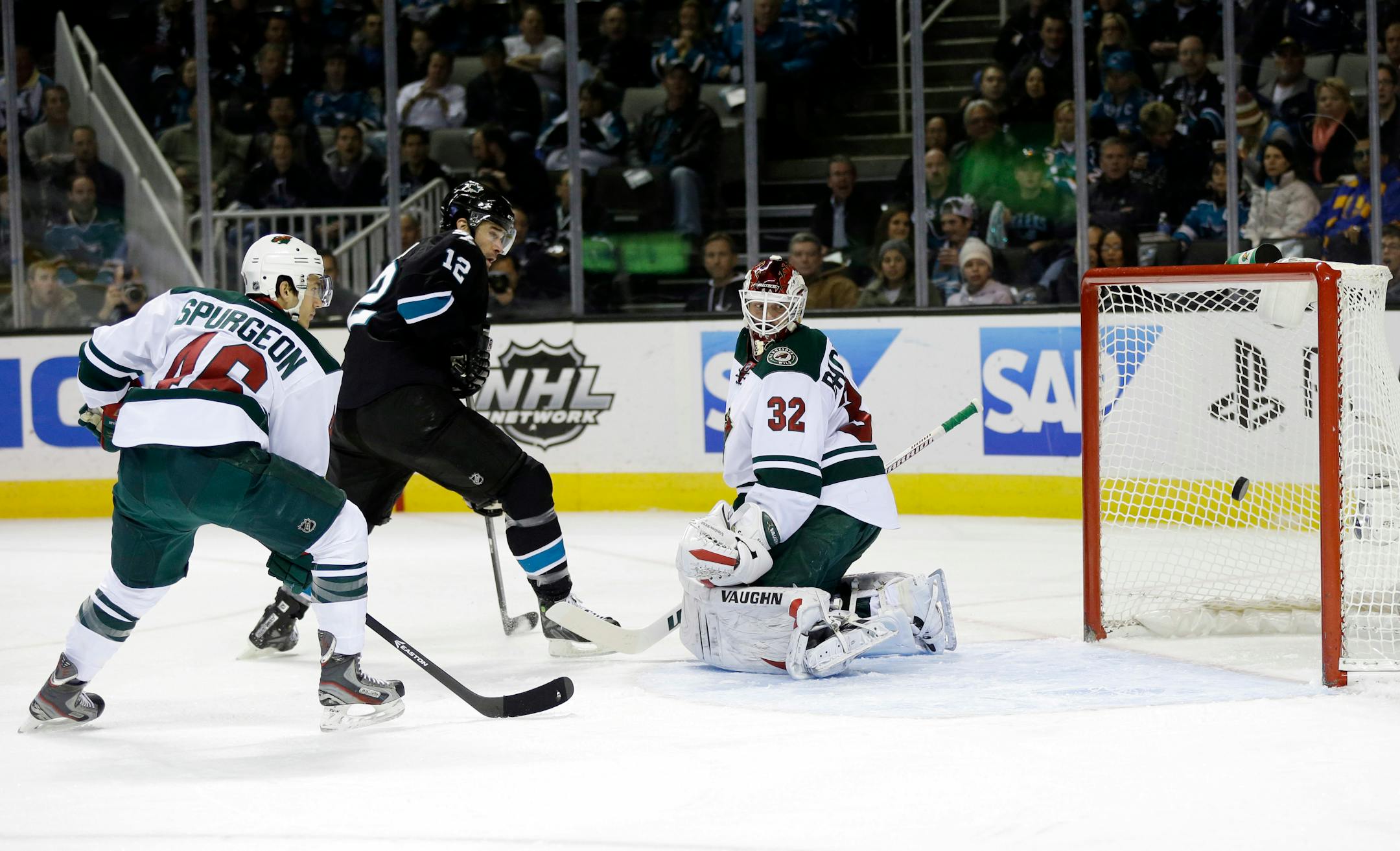 Minnesota Wild goalie Niklas Backstrom, right, of Finland, is beaten for a goal on a shot by San Jose Sharks' Joe Pavelski as Sharks center Patrick Marleau (12) and Wild defenseman Jared Spurgeon watch during the first period of an NHL hockey game on Thursday, Dec. 12, 2013, in San Jose, Calif. (AP Photo/Marcio Jose Sanchez)