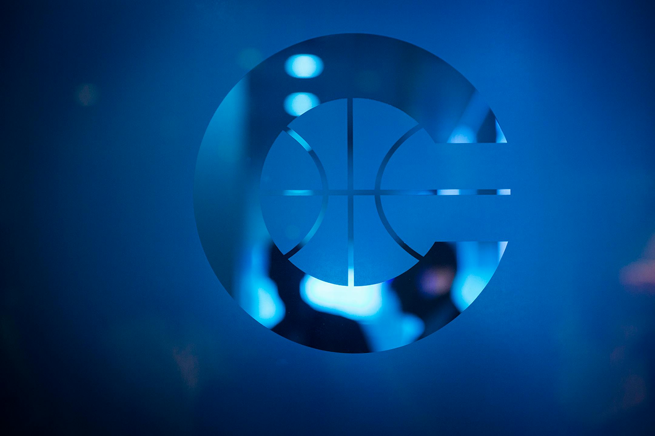 People are seen through the frosted blue glass at the entrance to the new Timberwolves and Lynx offices at Mayo Clinic Square in downtown Minneapolis on Wednesday, June 17, 2015.
