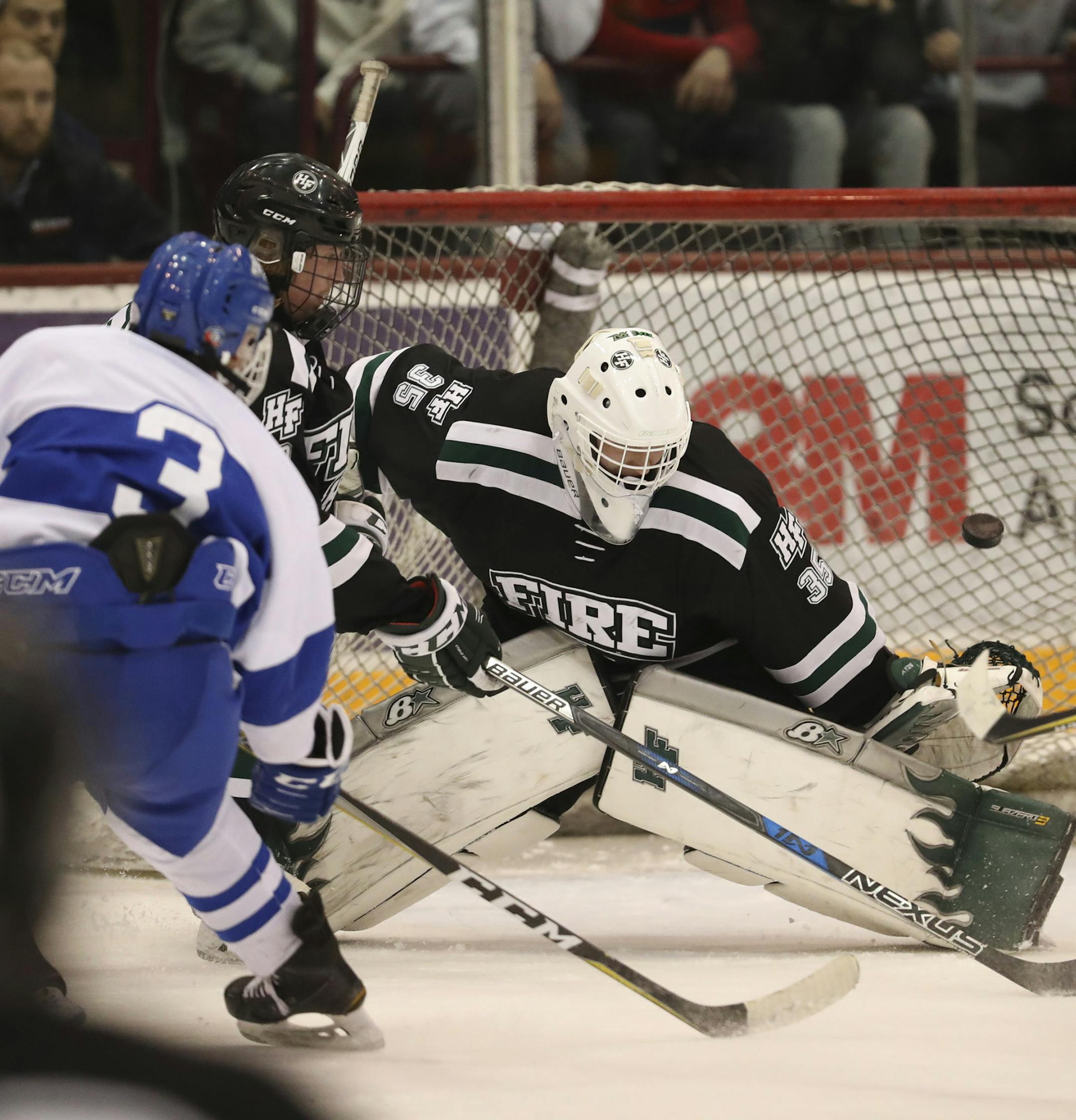 Minnetonka's Josh Luedtke (3) hit the upper right corner of the net to beat Holy Family goalie Conan Hayton and win the game in the second overtime Wednesday night. ] JEFF WHEELER ï jeff.wheeler@startribune.com Minnetonka beat Holy Family 5-4 in two overtimes to win the Class 2A, Section 2 boys' hockey tournament championship Wednesday night, February 28, 2018 at 3M Arena at Mariucci in Minneapolis.