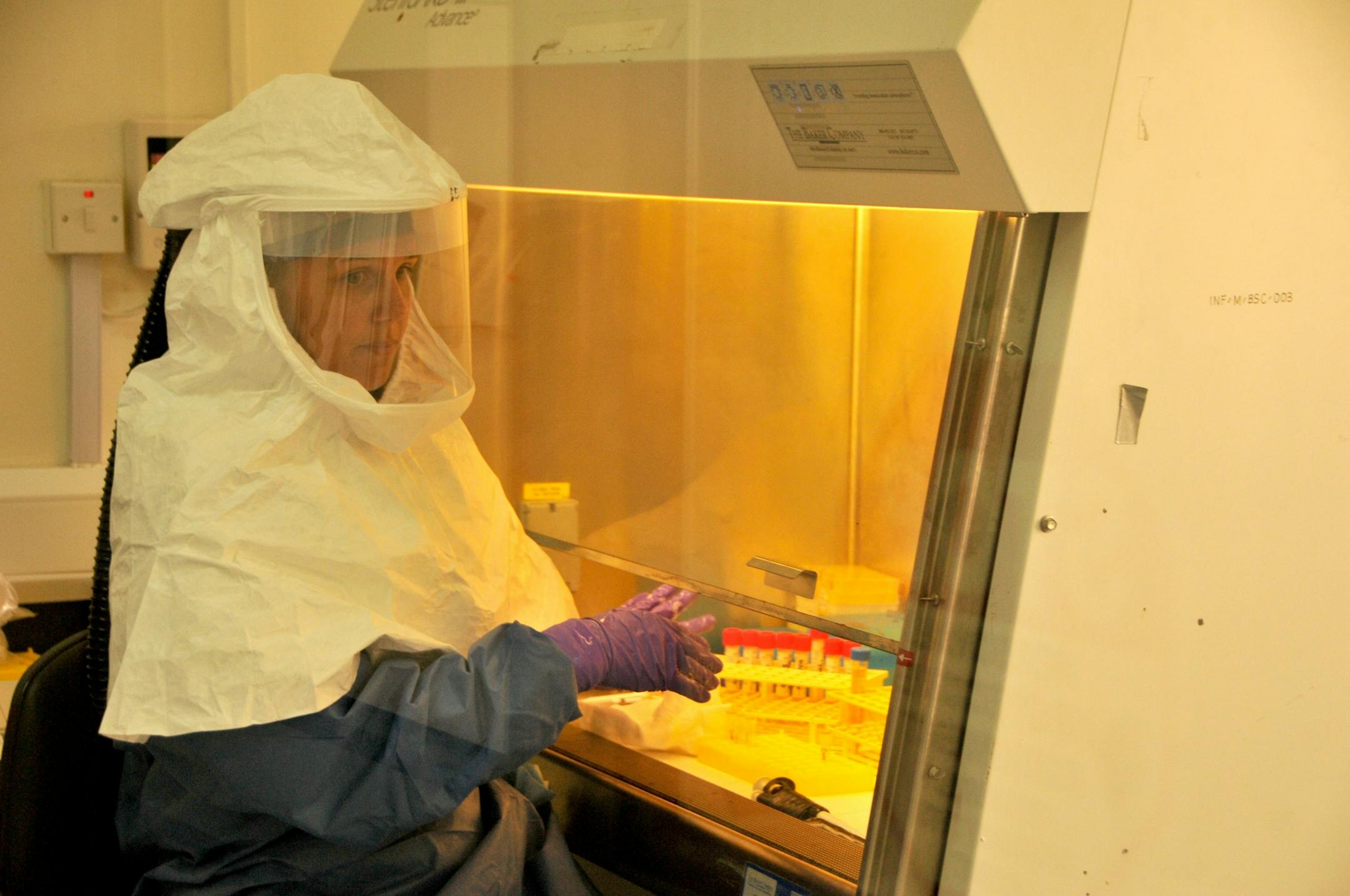 A medical worker from the U.S. Centers for Disease Control and Prevention, researchers who are working on the Ebola outbreak in Uganda, at their laboratory in Entebbe 42kms (29 miles) from the capital Kampala Thursday Aug. 2, 2012. The latest Ebola outbreak in Uganda has dimmed hopes of a successful year for the country's growing tourism industry, government officials and tour operators said as tourists began to cancel trips amid rising cases of the deadly disease in the East African country. Ho
