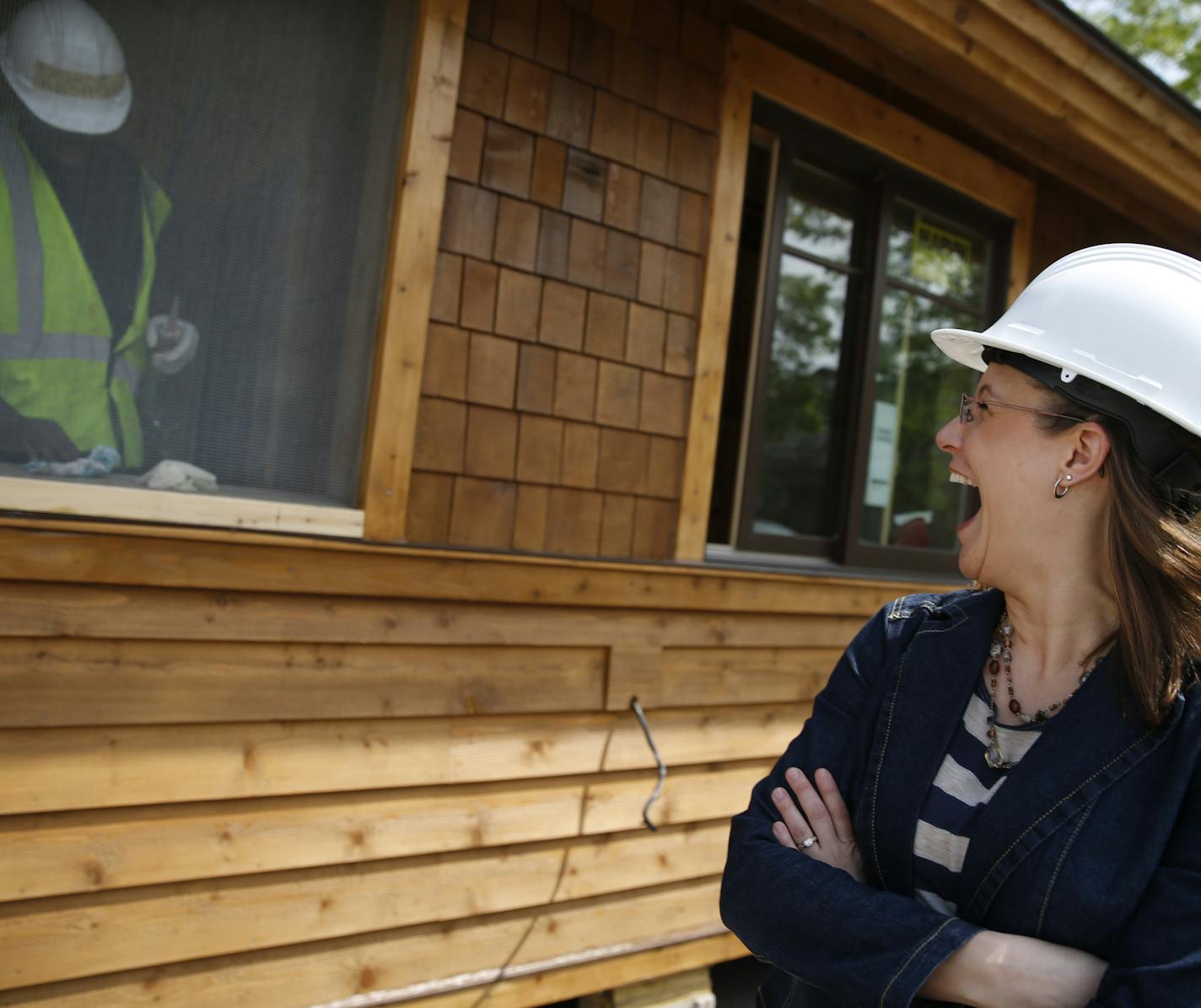 At Summit Academy OIC, Paris Otremba, a human ressource manager with PCL Construction Services chatted with Briant Kemp(cq) who was caulking the window on a cabin being built for the DNR. Kemp, after 20 weeks of training, will receive a pre-apprentice certificate for construction work. ] richard tsong-taatarii@startribune.com