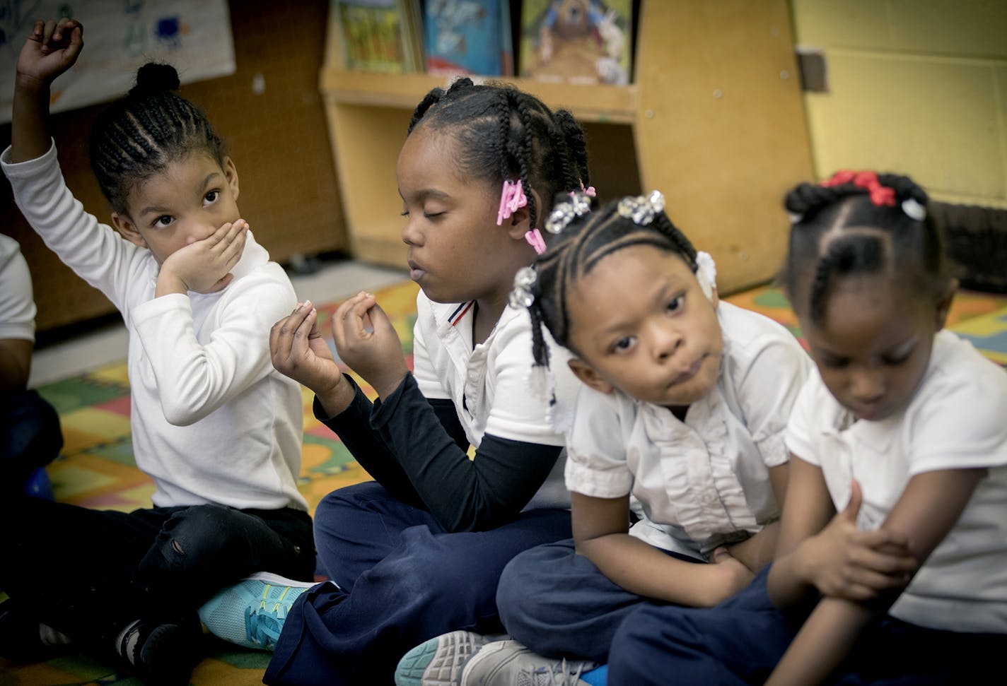 A pre-k students at Marcus Garvey Elementary School turned to yoga to calm her surroundings during a class activity, Tuesday, March 21, 2017 in Chicago, IL. ] ELIZABETH FLORES &#xef; liz.flores@startribune.com