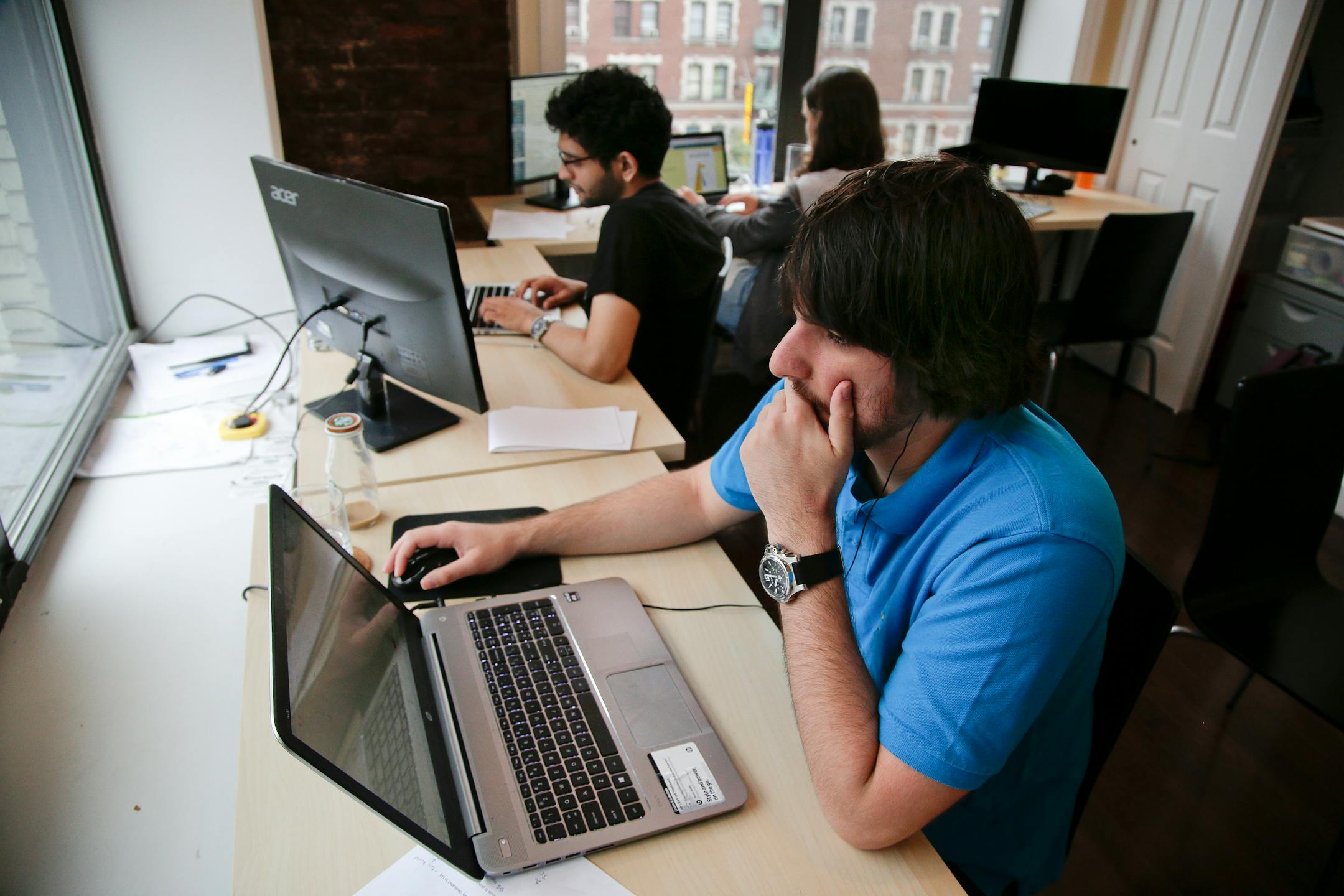 Draftpot co-founder and CEO Joey Levy, foreground, works with co-founder and CTO Joshua Hughes, center, and co-founder and developer Jessica Vandebon at the Fantasy Football operation's workspace, Wednesday, Sept. 30, 2015, in New York. After starting up from their dorm rooms at Columbia University earlier this year, the operation paid out $220,000 in it's first week online.