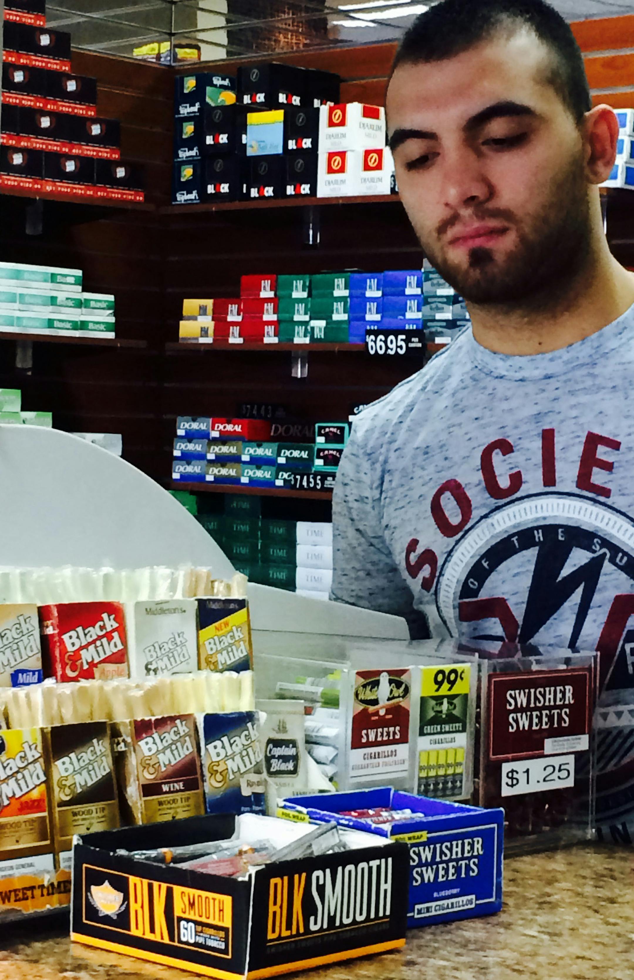 Ziad Alobaidi of the Royal Tobacco shop in Brooklyn Center, looked at the inventory of little cigars he sells.