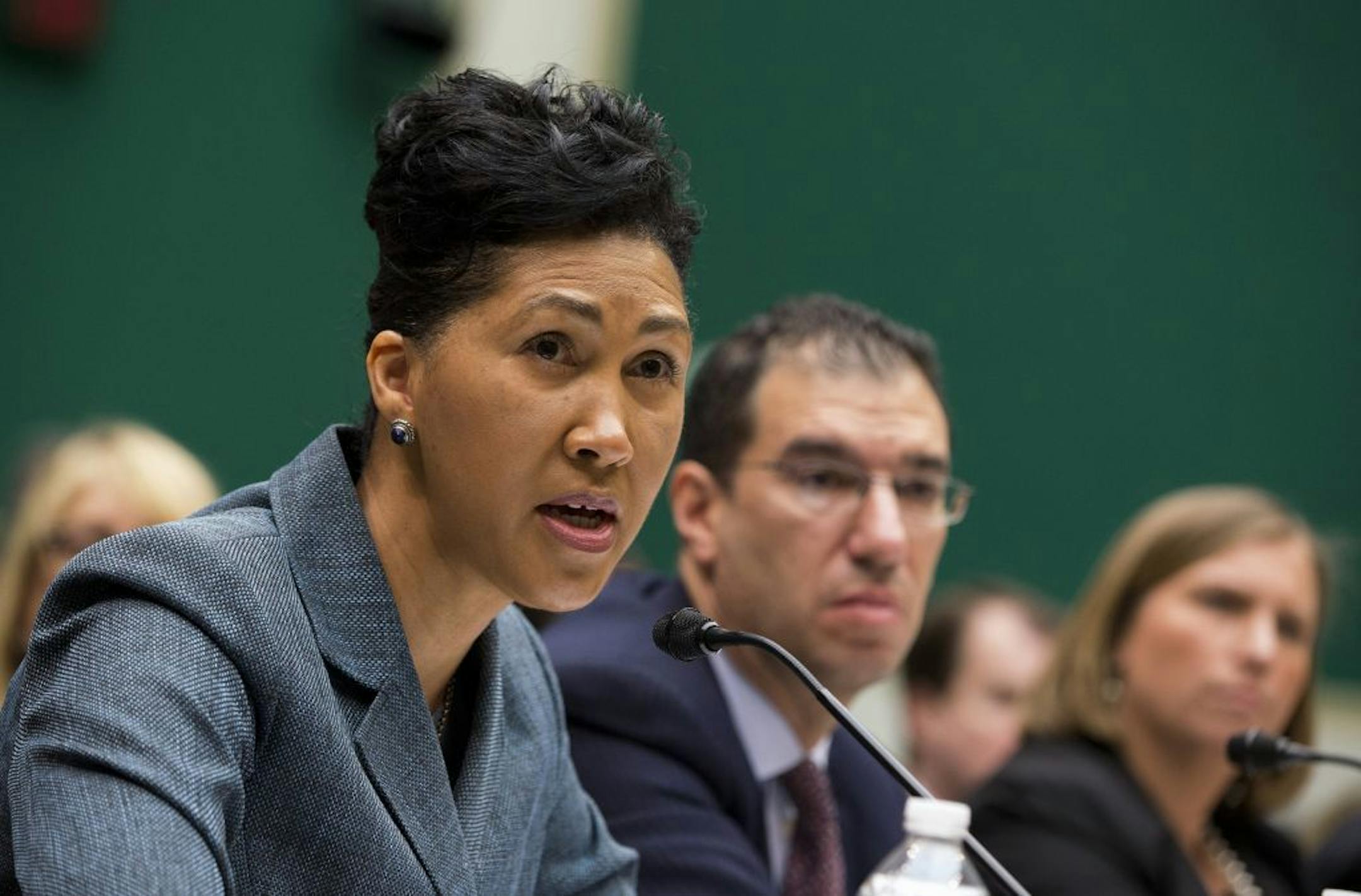 Cheryl Campbell, Senior vice president of CGI Federal, left, testifies on Capitol Hill in Washington, Thursday, Oct. 24, 2013, before the House Energy and Commerce Committee hearing with contractors that built the federal government's health care websites. From left, Campbell, Andrew Slavitt, group executive vice president for Optum/QSSI, and Lynn Spellecy, corporate counsel for Equifax Workforce Solutions.