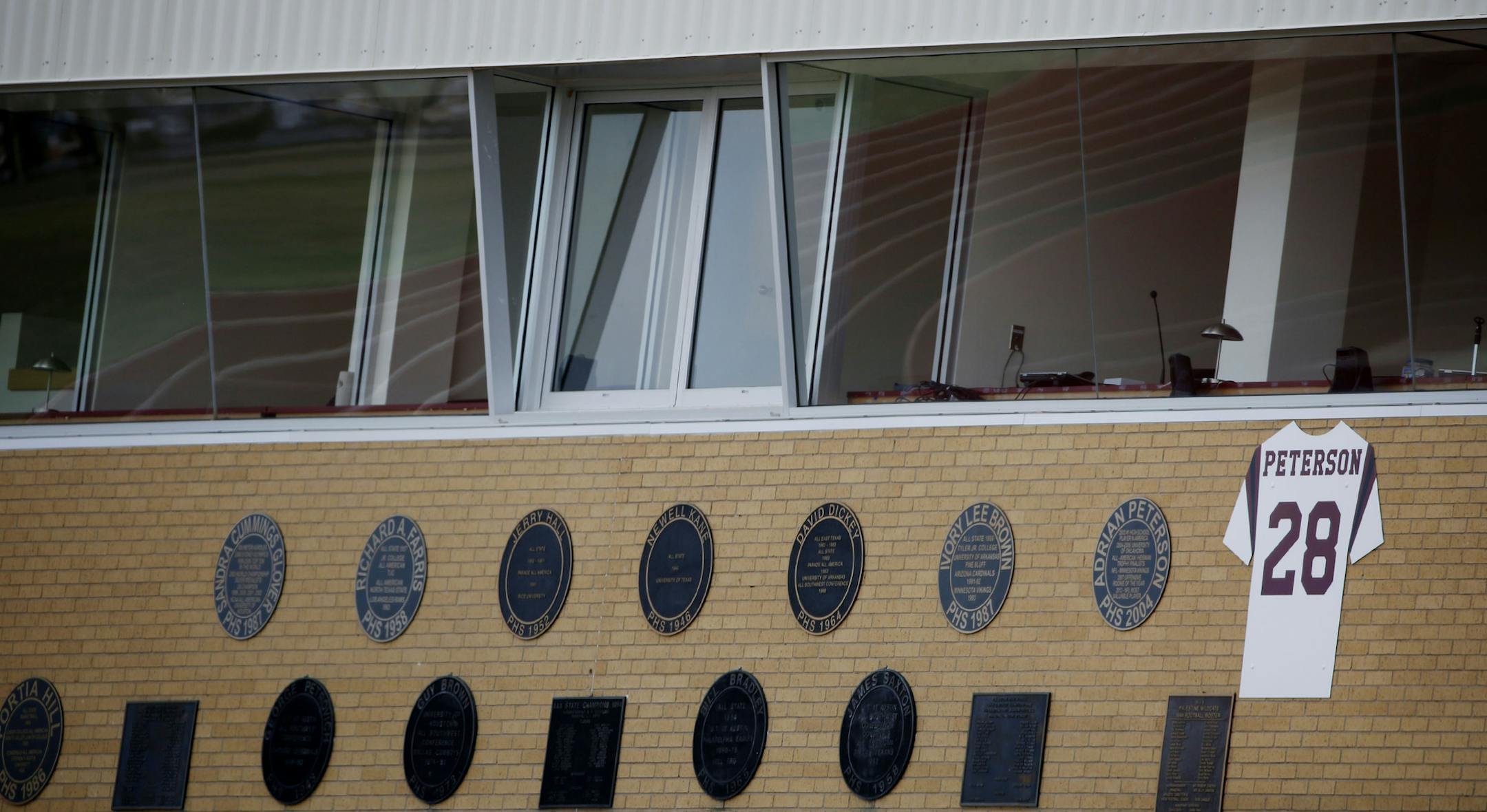 The retired Palestine High School jersey and number of Adrian Peterson hang under the press box at Wildcat Stadium in Palestine, Texas Sunday September 14, 2014. Adrian Peterson, who is from Palestine, was indicted on charges that he beat his 4-year-old son. (Andy Jacobsohn)