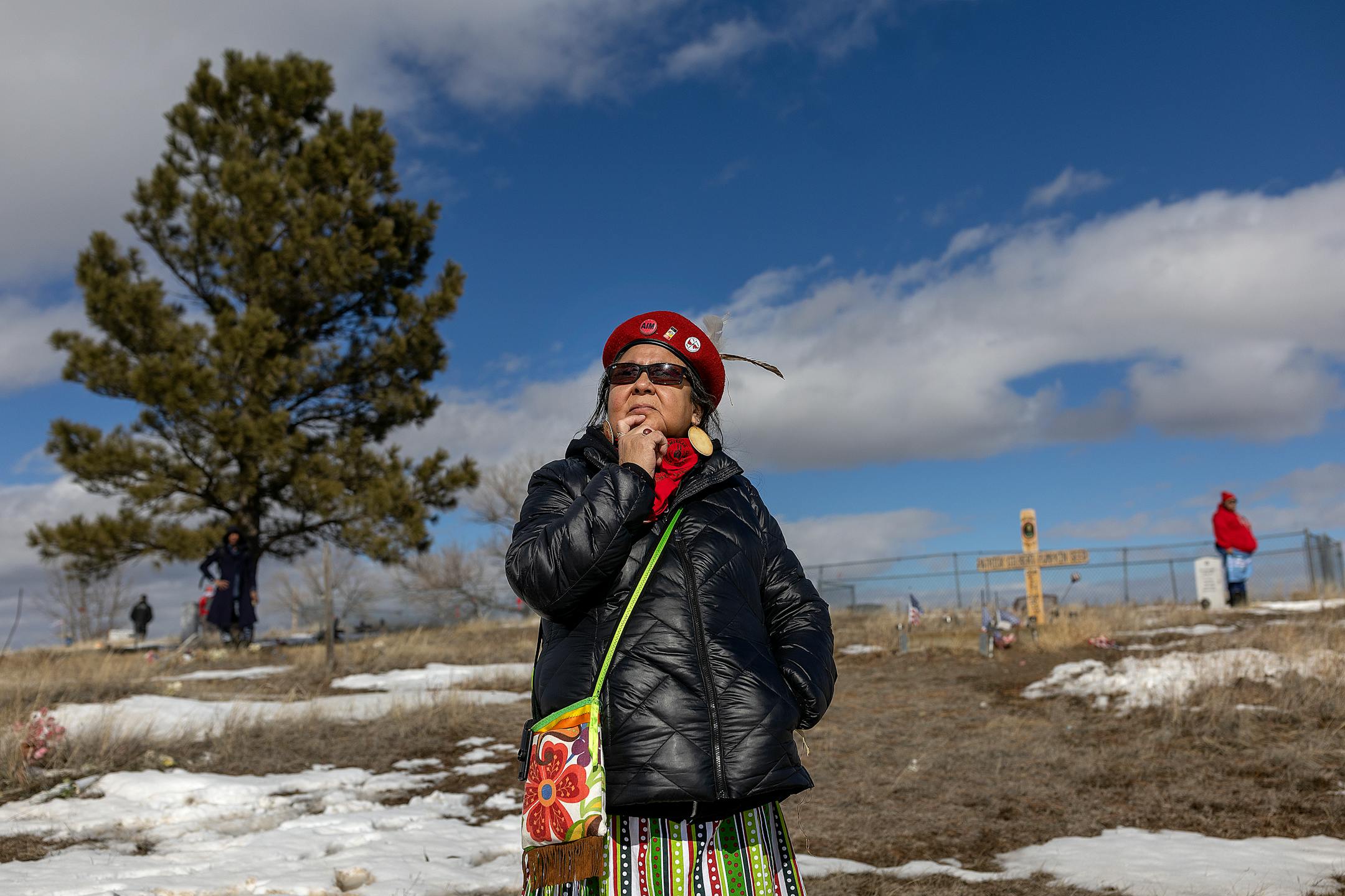 American Indian Movement Minnesota director Lisa Bellanger watches as members and supporters make their way up the memorial hill from the Four Directions March to honor the AIM Warriors of Wounded Knee of 1973 in Wounded Knee, SD, on Monday, Feb. 27, 2023.