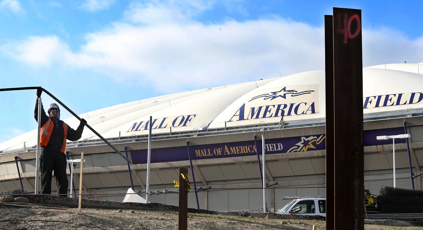 A construction worker prepared a fence for the start of the official demolition of the Metrodome as the Minnesota Vikings will move out at the end of this season.