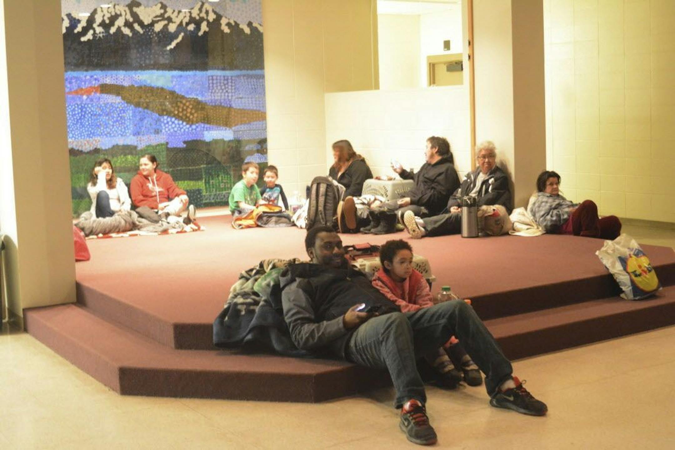 Abdulai Salam and his daughter Mina at about 2:30 a.m. Tuesday, Jan. 23, 2018, wait for the all-clear at Homer High School during a tsunami alert for Homer, Alaska. The city of Homer issued an evacuation order for low-lying areas shortly after an earthquake hit.