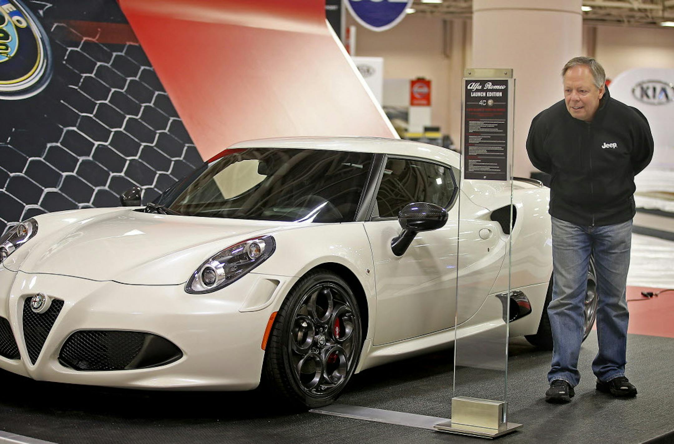 Bob Dunn, the area sales manager for the FCA Group, checked out the Alfa Romeo as they set up for the annual Minneapolis auto show, Friday, March 6, 2015 in Minneapolis, MN. The show starts Saturday at the Minneapolis Convention Center. ] (ELIZABETH FLORES/STAR TRIBUNE) ELIZABETH FLORES • eflores@startribune.com