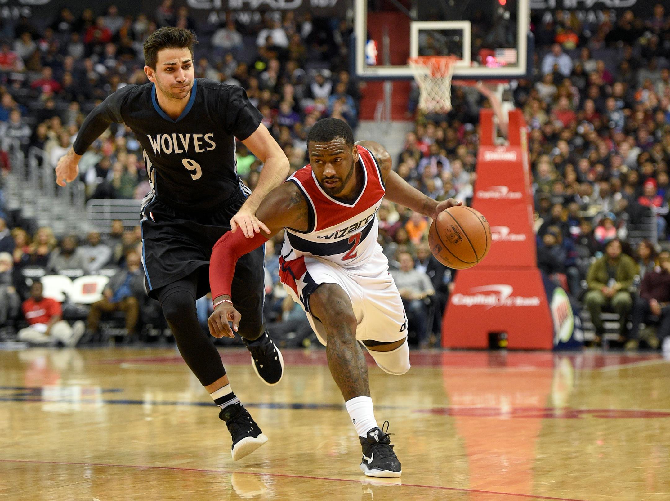 Washington Wizards guard John Wall (2) dribbles against Minnesota Timberwolves guard Ricky Rubio (9), of Spain, during the second half of an NBA basketball game, Friday, Jan. 6, 2017, in Washington. (AP Photo/Nick Wass)