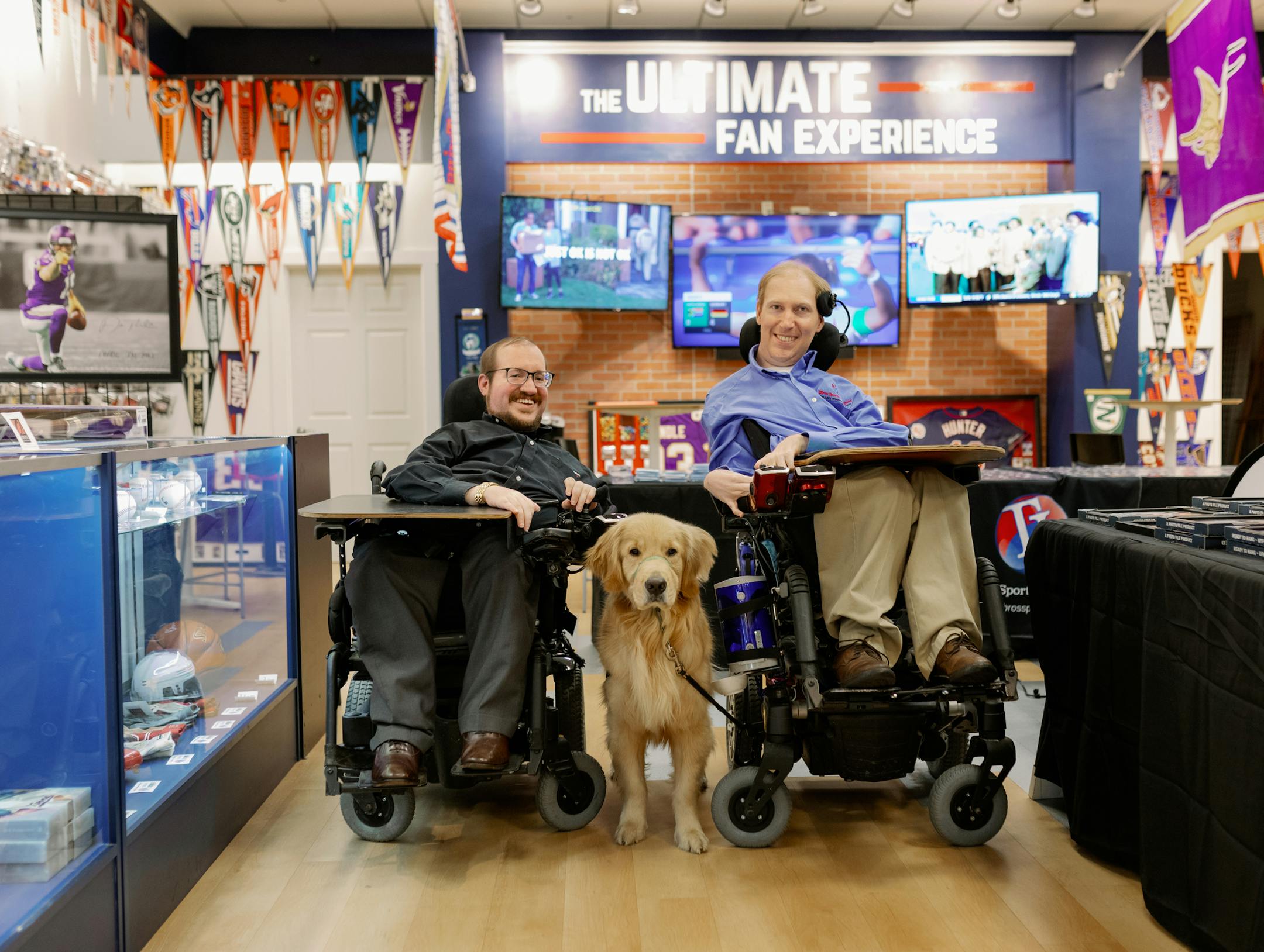 Todd Hallada and Tom Hallada, founders of 2 Bros Sports Collectibles, with their service dog, Juneau. Photo: 2Bros