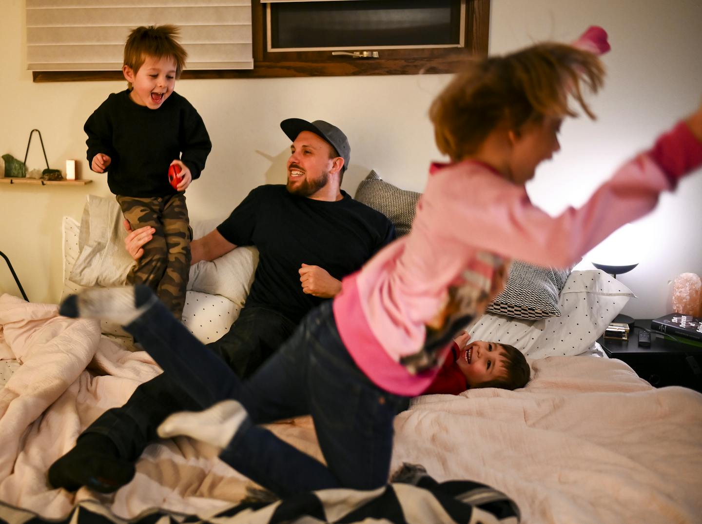 A beatmaker taking a (pillow) beating: Aaron "Lazerbeak" Mader played with his three children, twin brothers Lou, left, and Cam, both 4, and daughter Penny, 6.