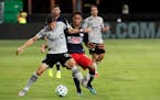 Montreal Impact's Jukka Raitala, front left, battles for position with New England Revolution's Brandon Bye during the first half of an MLS soccer mat