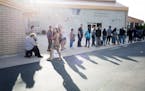 Voters stand in line, where the wait times reached over two hours, on Election Day outside the Maryvale Church of the Nazarene in Phoenix, Ariz., Nov.